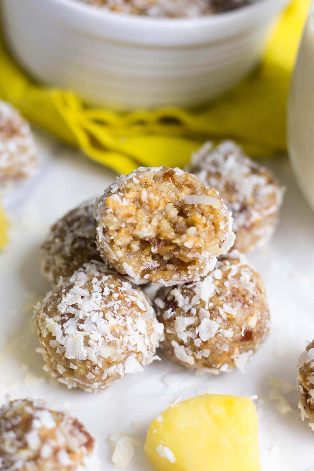 Healthy and filled with energizing ingredients, these pina colada energy bites are a sweet and healthy snack that will keep you satisfied all day. It's made with raw ingredients like cashews and macadamia nuts, plus dried fruit and coconut. This energy bite recipe will transport you to the beach!