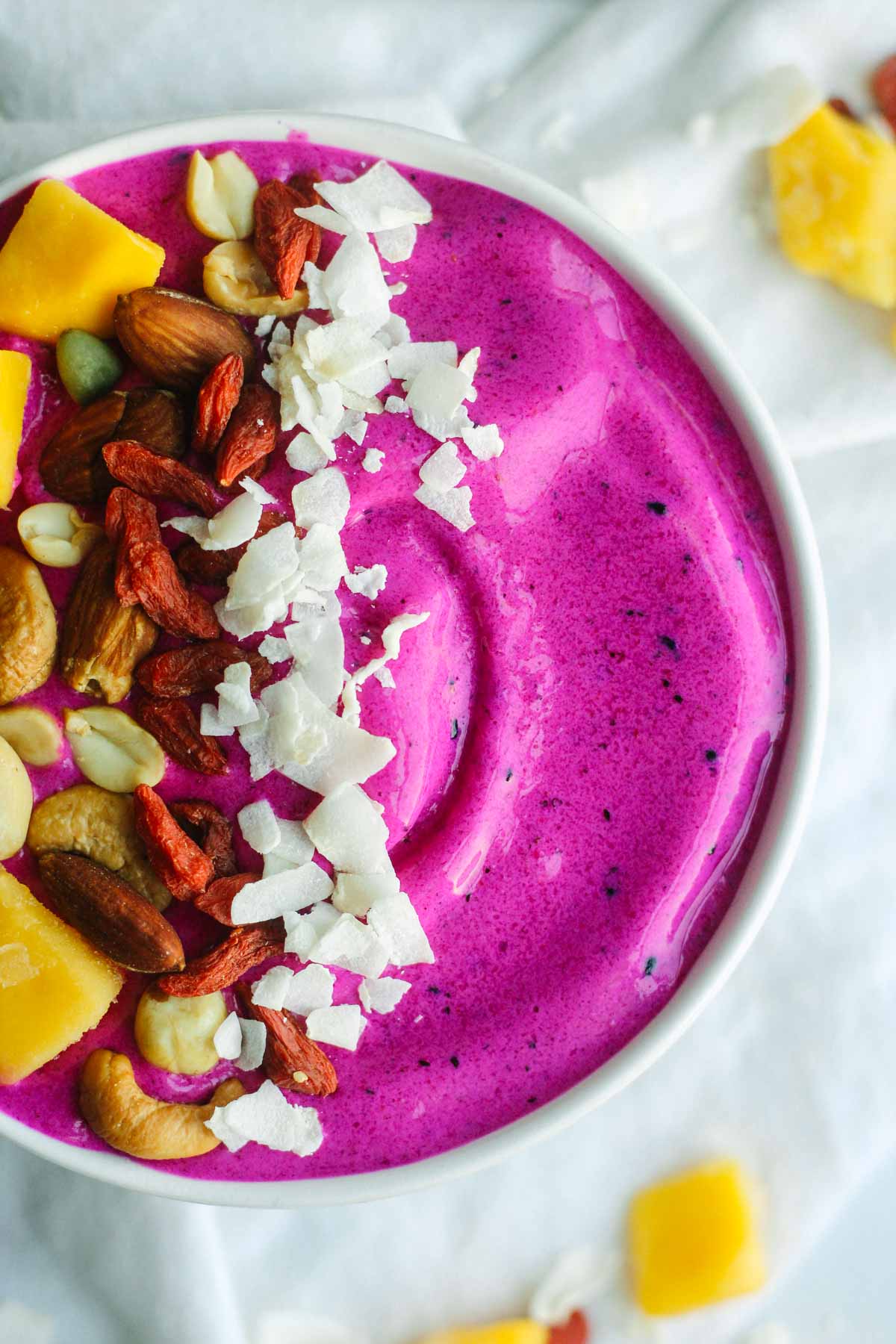 how to make a pitaya bowl with fresh and healthy toppings like coconut and mango