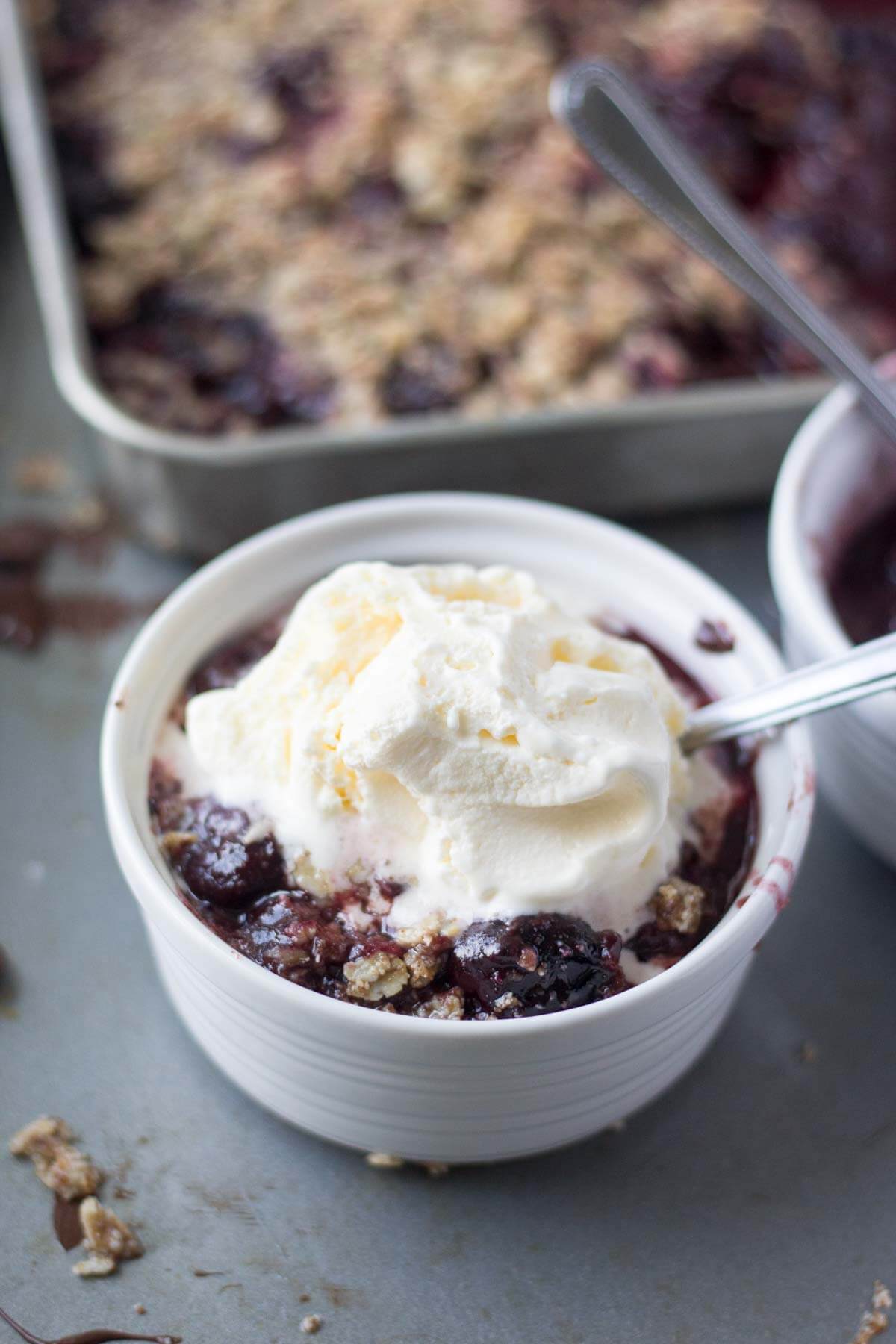 These easy cherry crisp recipe is made with frozen cherries and dark chocolate and topped with a gluten free oat crust. It's the perfect summer dessert recipe!