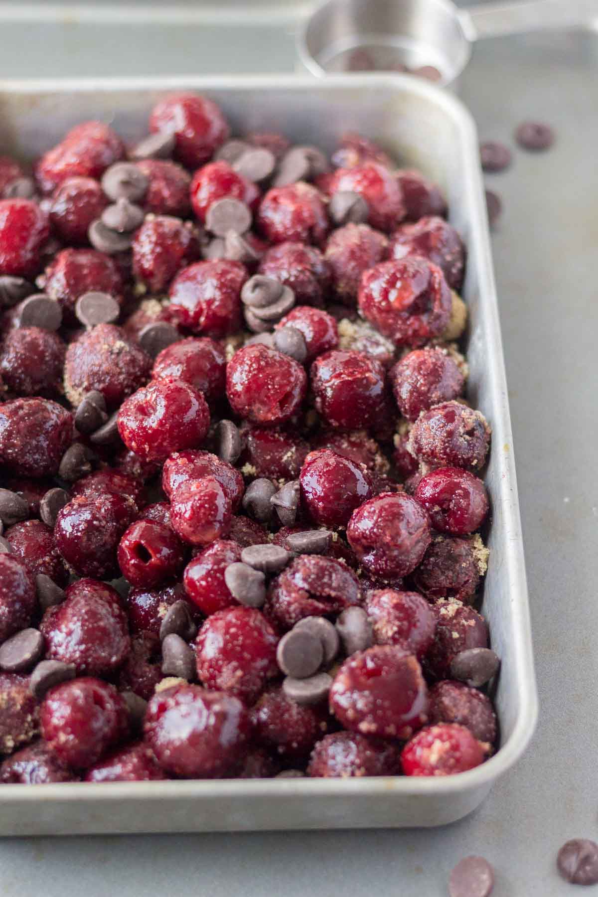 white dish filled with frozen cherries and dark chocolate