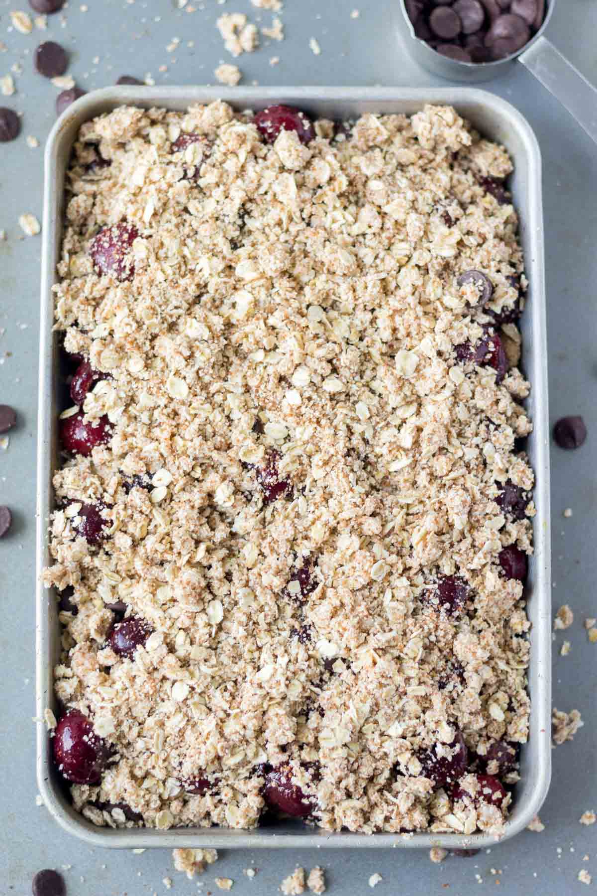 Easy cherry crisp recipe with a gluten free oat crust in a 9x13 on the counter