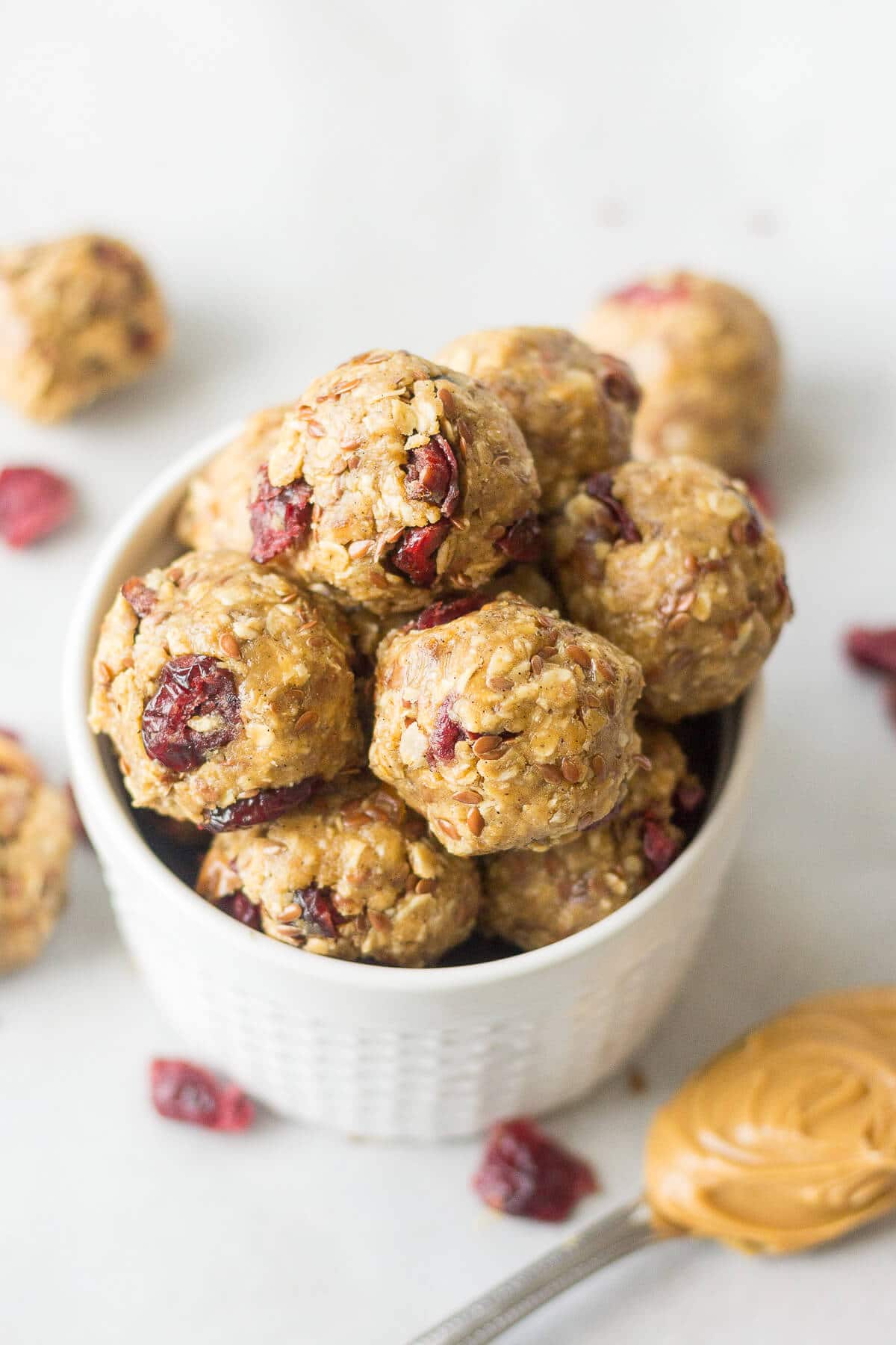 PB & J Protein Balls in a white bowl on a countertop