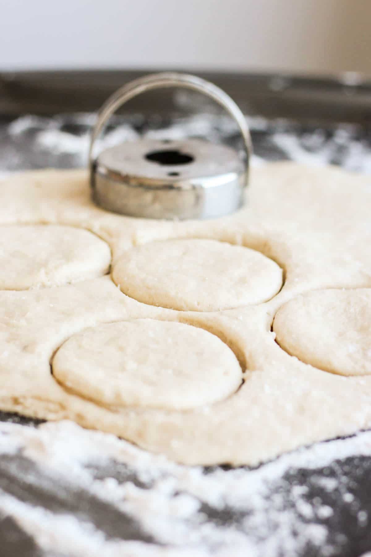 cookie cutter cutting circles for dough of roasted strawberry cobbler