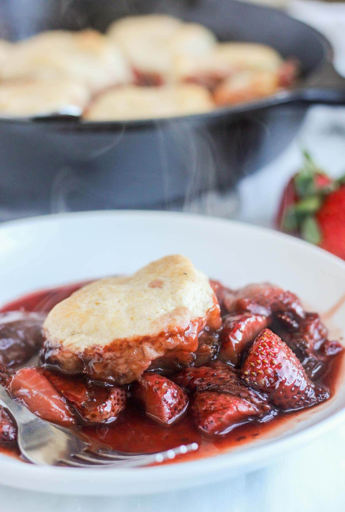 Plate of steaming roasted strawberry cobbler