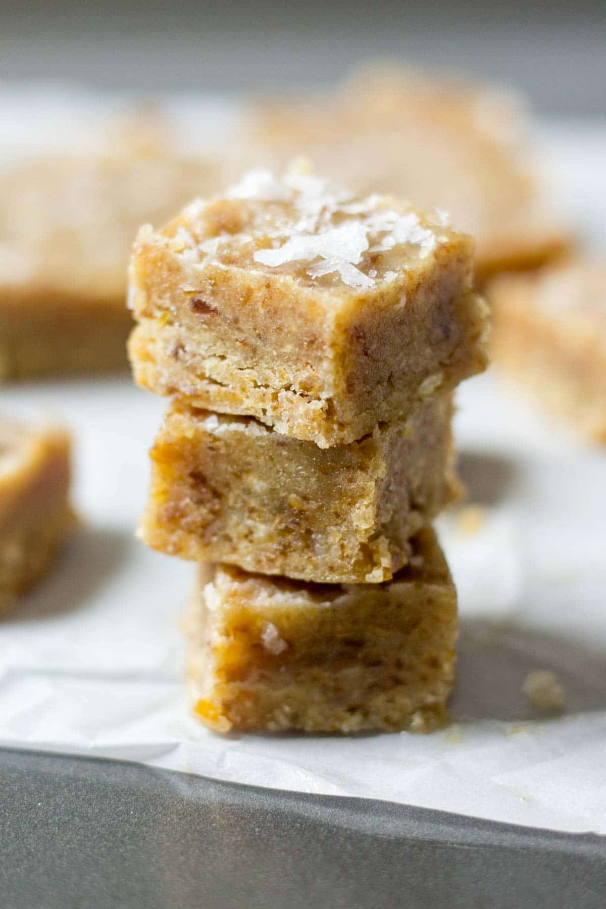 You will be amazed by these healthy caramels! They're made with tahini, dates and coconut oil. Blend all of the ingredients in the food process and freeze in a loaf pan. Sprinkle with sea salt and dunk them in dark chocolate. These easy healthy salted caramels will be your go to dessert recipe.