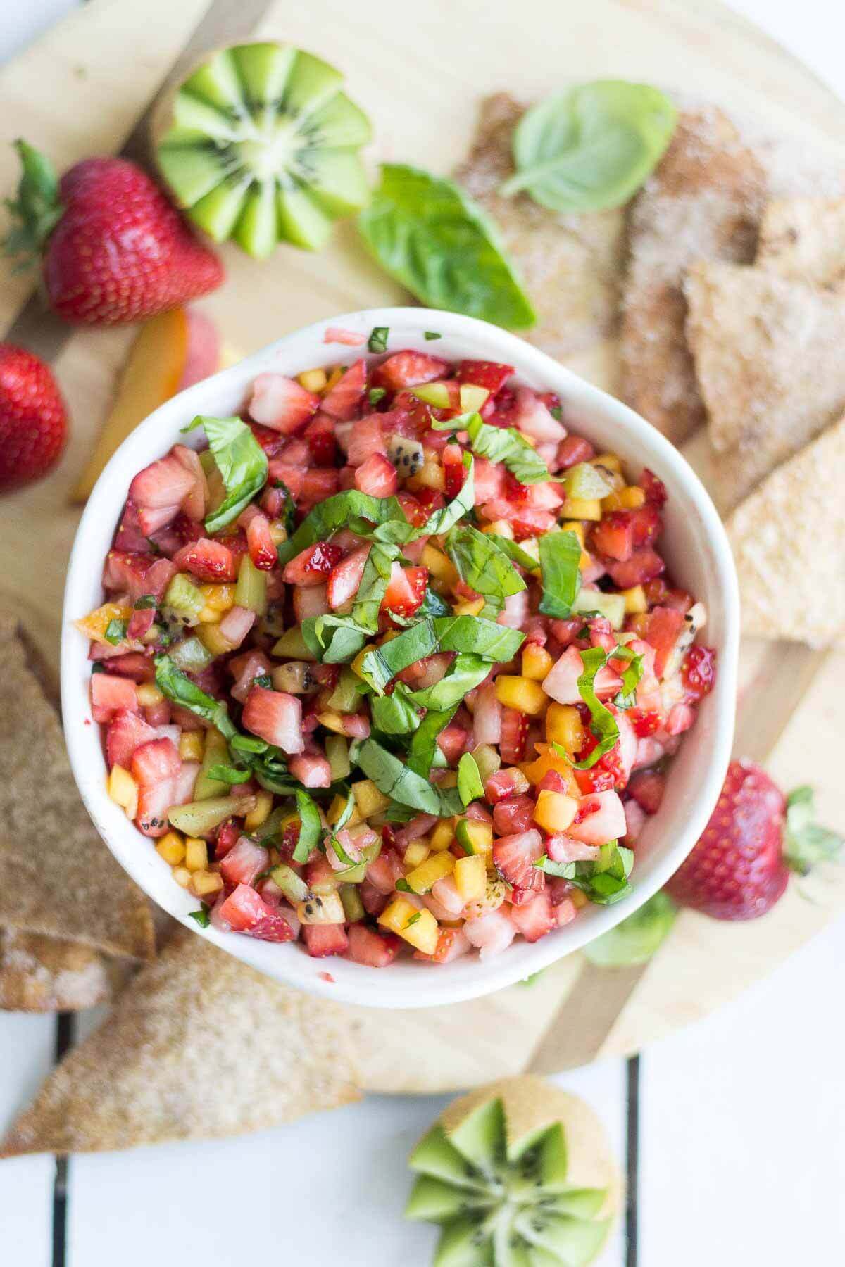 Sweet and healthy at the same time, this fruit salsa is made with fresh fruit and scooped up with a crunchy homemade cinnamon sugar pita chips. This healthy summer dessert means no oven and lots of healthy fruit. You're summer parties will be complete with this healthy recipe.