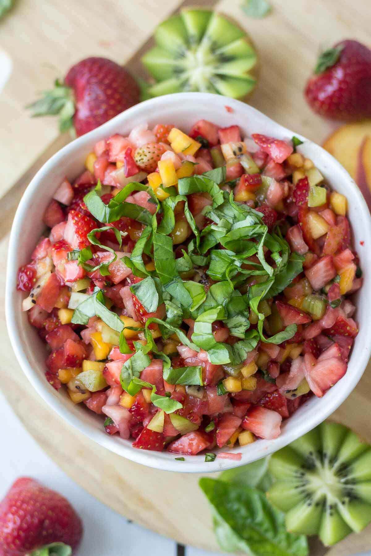 Sweet and healthy at the same time, this fruit salsa is made with fresh fruit and scooped up with a crunchy homemade cinnamon sugar pita chips. This healthy summer dessert means no oven and lots of healthy fruit. You're summer parties will be complete with this healthy recipe.