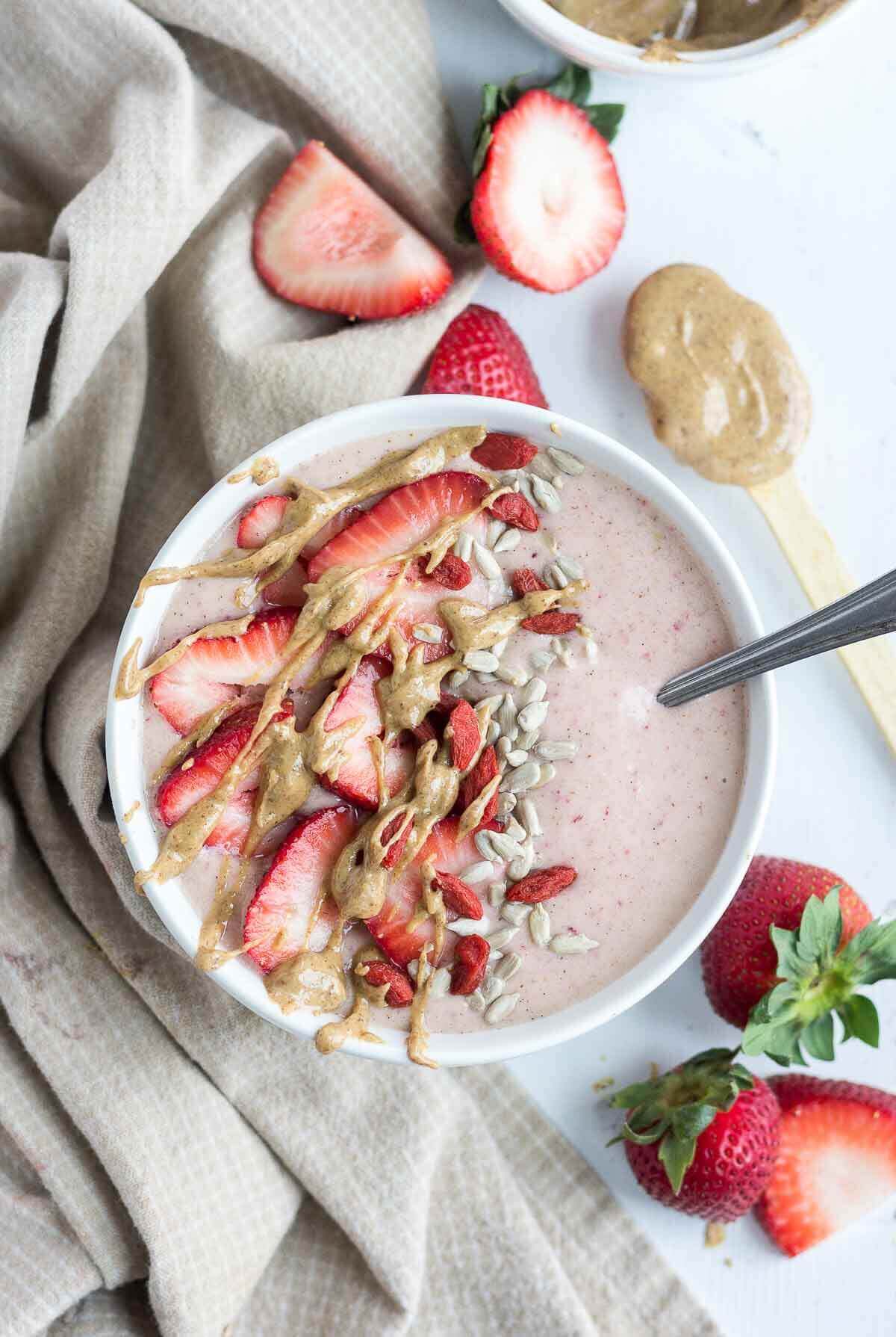 This PB & J Smoothie Bowl is made with fresh, raw ingredients and the perfect recipe to start your morning. The "jelly" comes from the strawberries and the "PB" comes from all natural almond butter! This sweet and satisfying healthy smoothie bowl will become your next go-to.