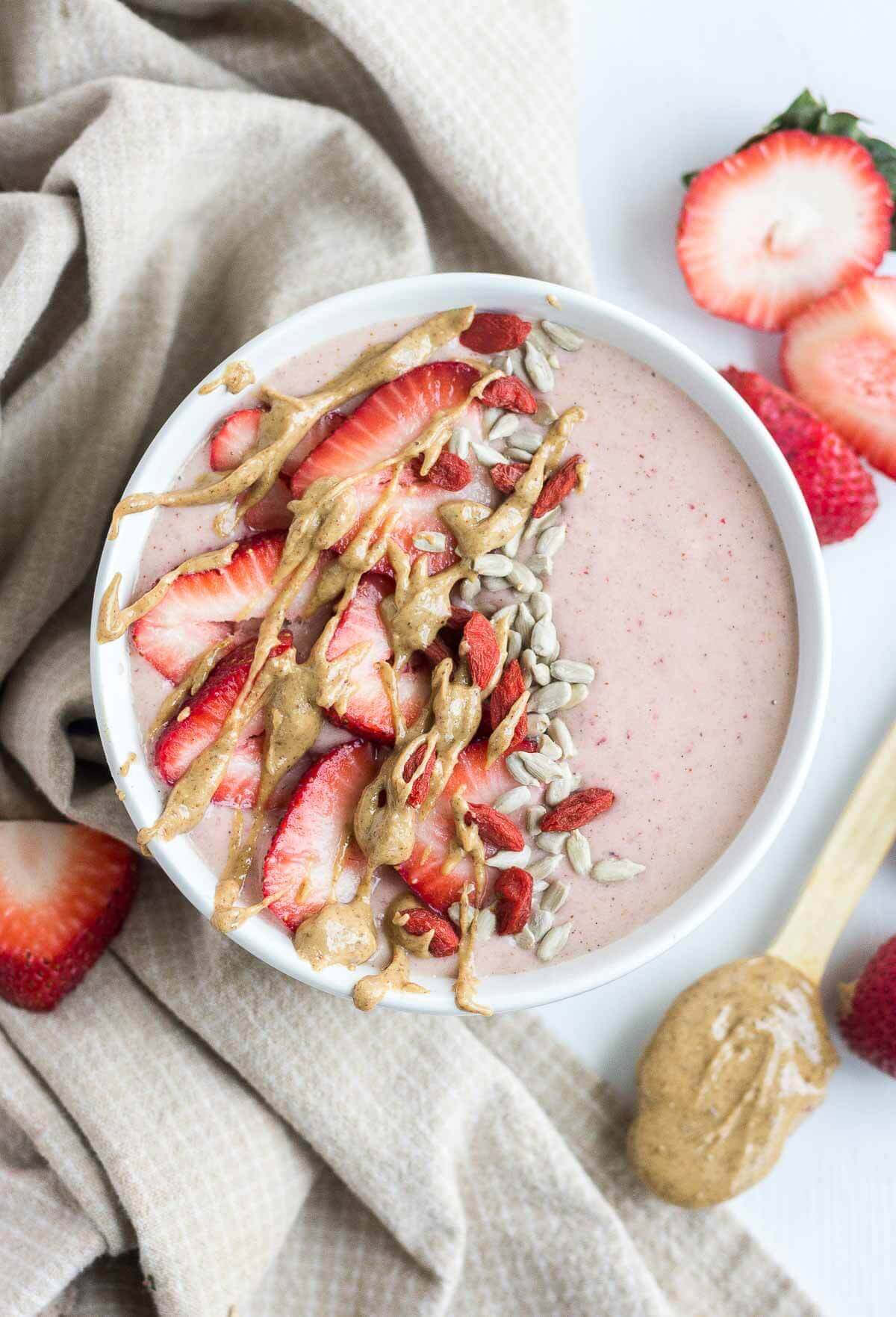 This PB & J Smoothie Bowl is made with fresh, raw ingredients and the perfect recipe to start your morning. The "jelly" comes from the strawberries and the "PB" comes from all natural almond butter! This sweet and satisfying healthy smoothie bowl will become your next go-to.