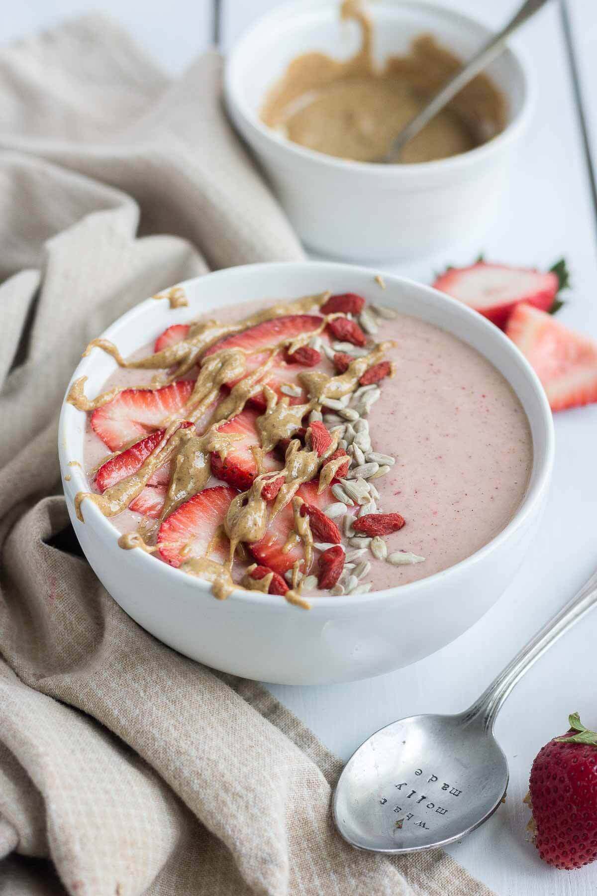 This PB & J Smoothie Bowl is made with fresh, raw ingredients and the perfect recipe to start your morning. The "jelly" comes from the strawberries and the "PB" comes from all natural almond butter! This sweet and satisfying healthy smoothie bowl will become your next go-to.