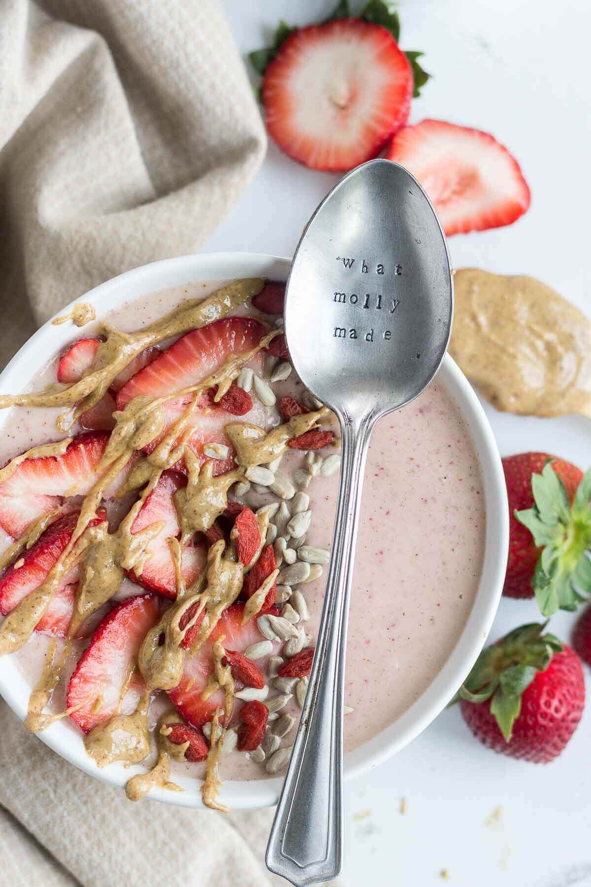 This PB & J Smoothie Bowl is made with fresh, raw ingredients and the perfect recipe to start your morning. The "jelly" comes from the strawberries and the "PB" comes from all natural almond butter! This sweet and satisfying healthy smoothie bowl will become your next go-to.