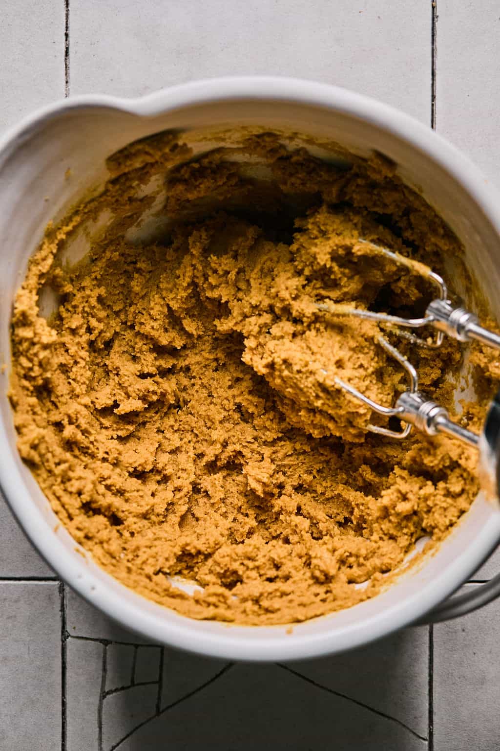 mixing flourless peanut butter cookies with an electric mixer.