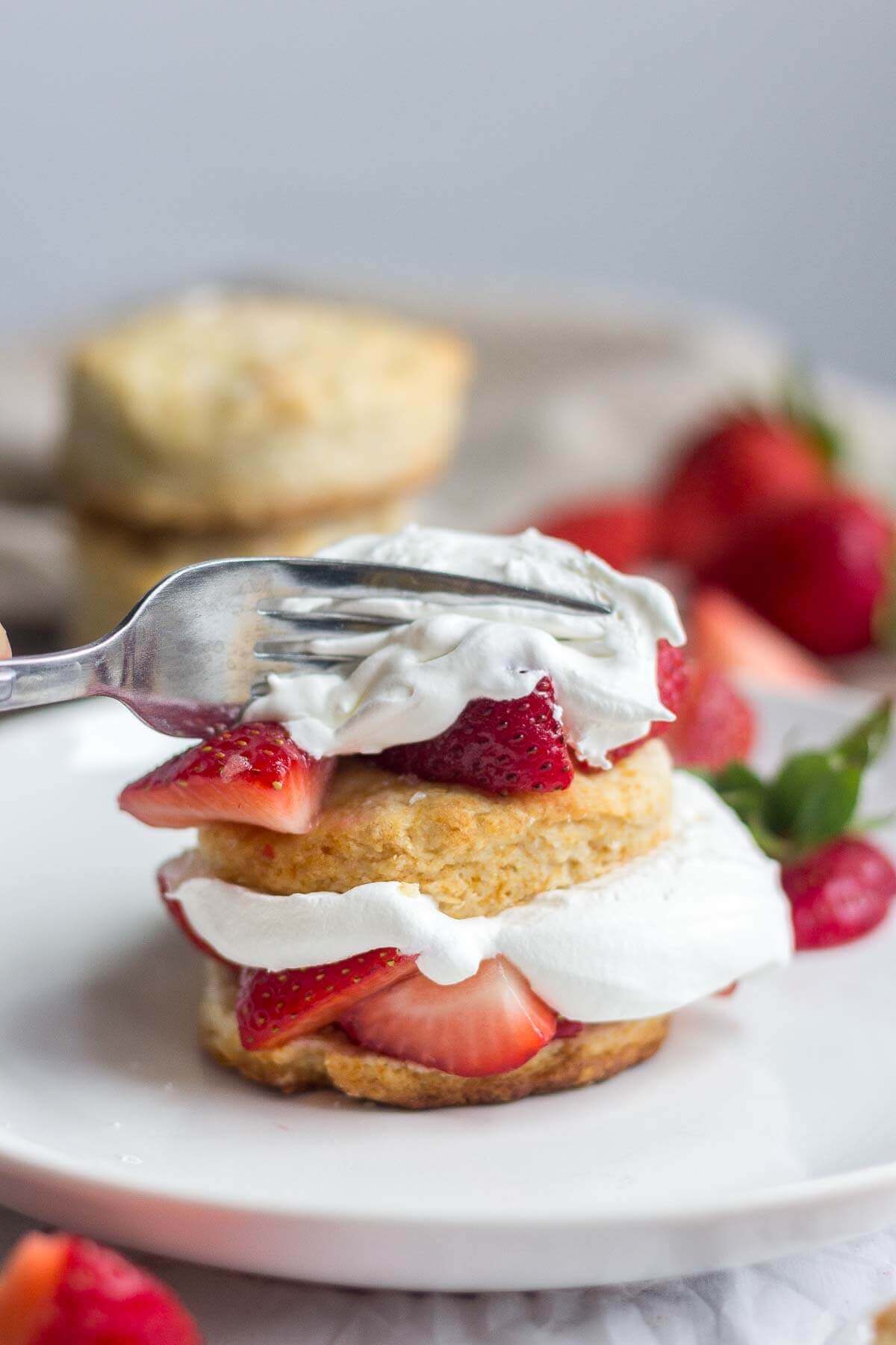 fork digging into piece of Healthy strawberry shortcake