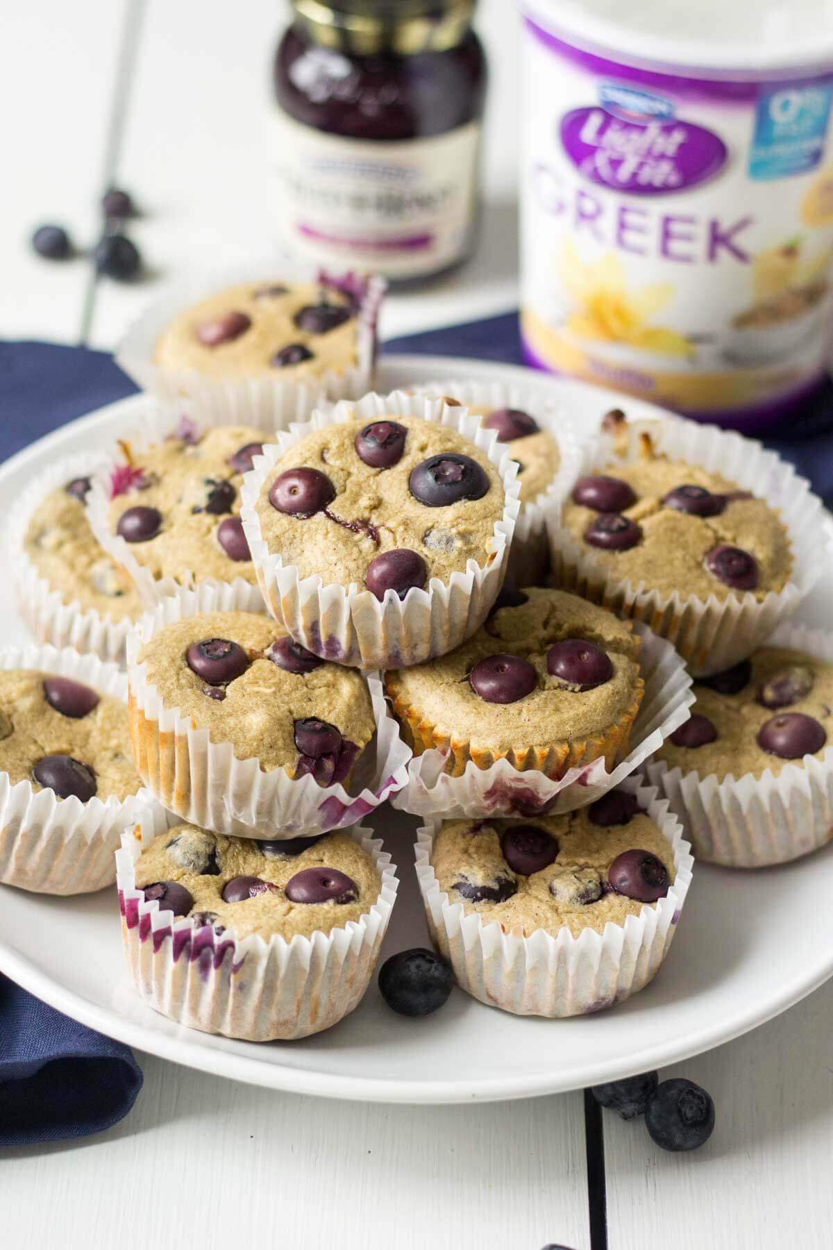 triple berry blender muffins stacked in a pyramid on a white plate