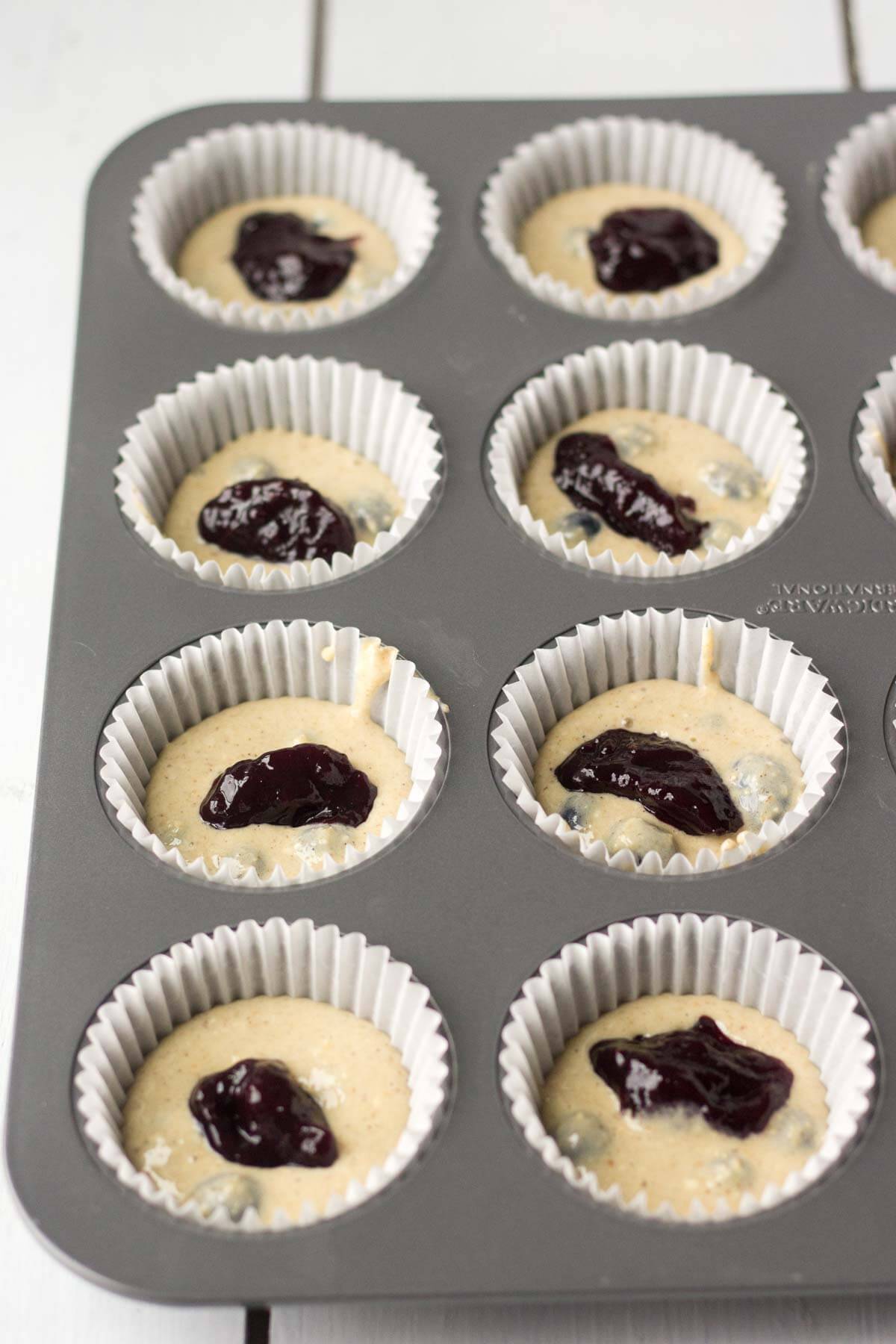 batter for triple berry blender muffins in a muffin tin