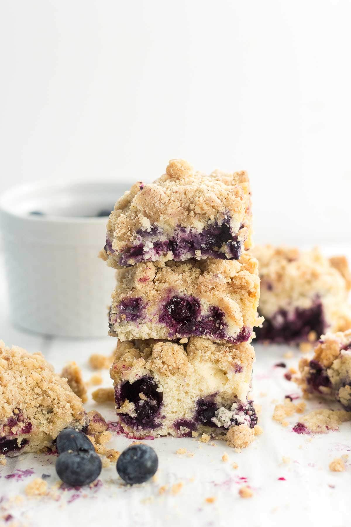 3 pieces of Brown Butter Blueberry Coffee Cake stacked on a counter