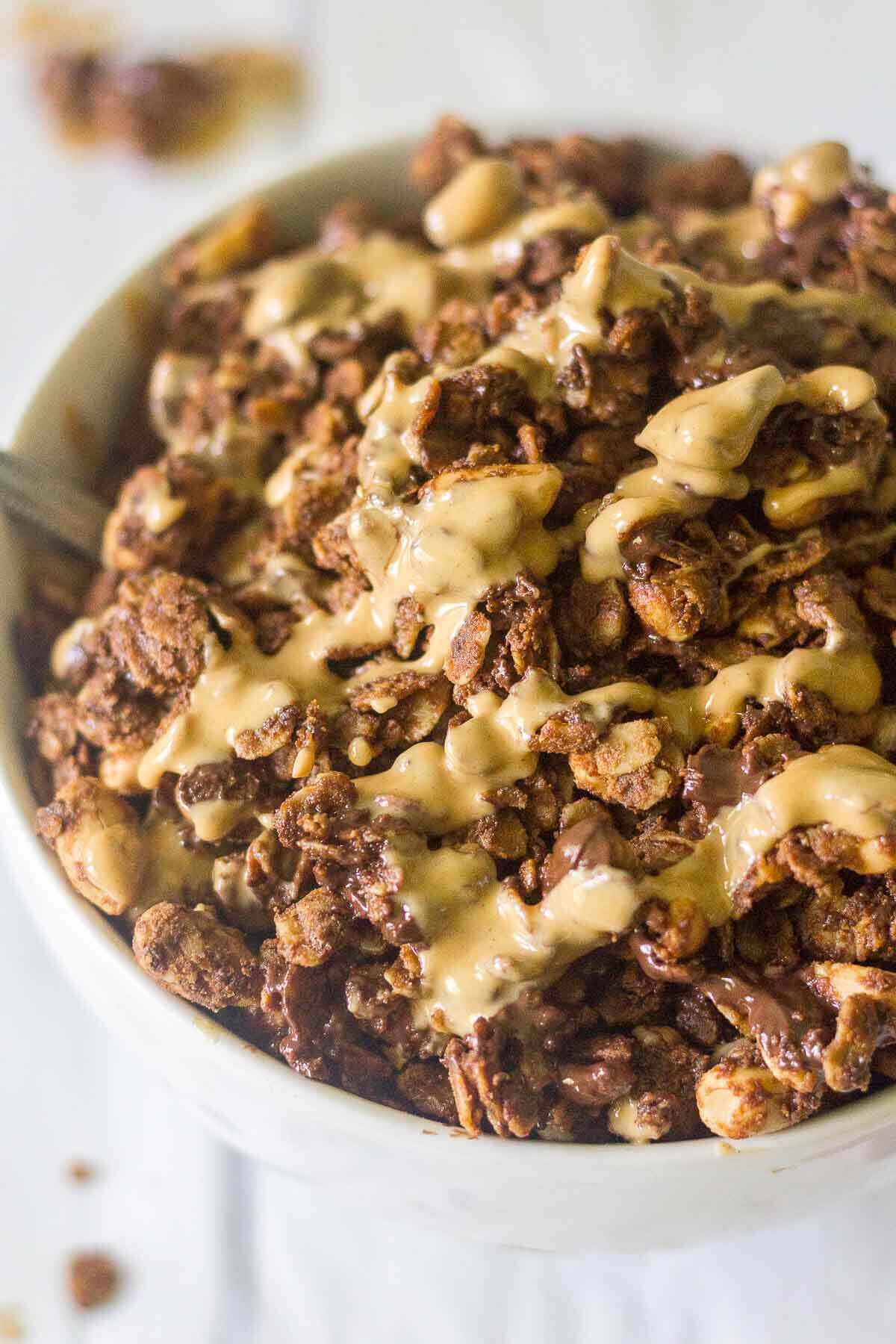 This Chocolate Peanut Butter Protein Granola is crunchy, flavorful and packed with healthy ingredients. It's a delicious way to start the day! The perfect breakfast recipe or snack recipe, this easy granola comes together in minutes and tastes so good.