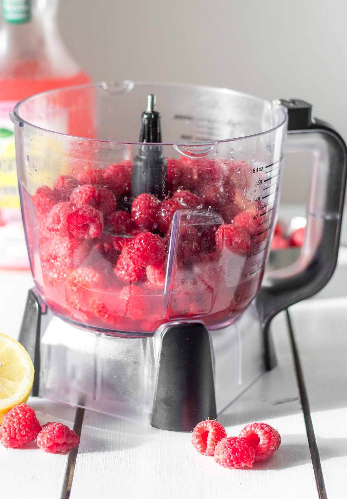 ingredients for raspberry lemonade granita placed in a food processor