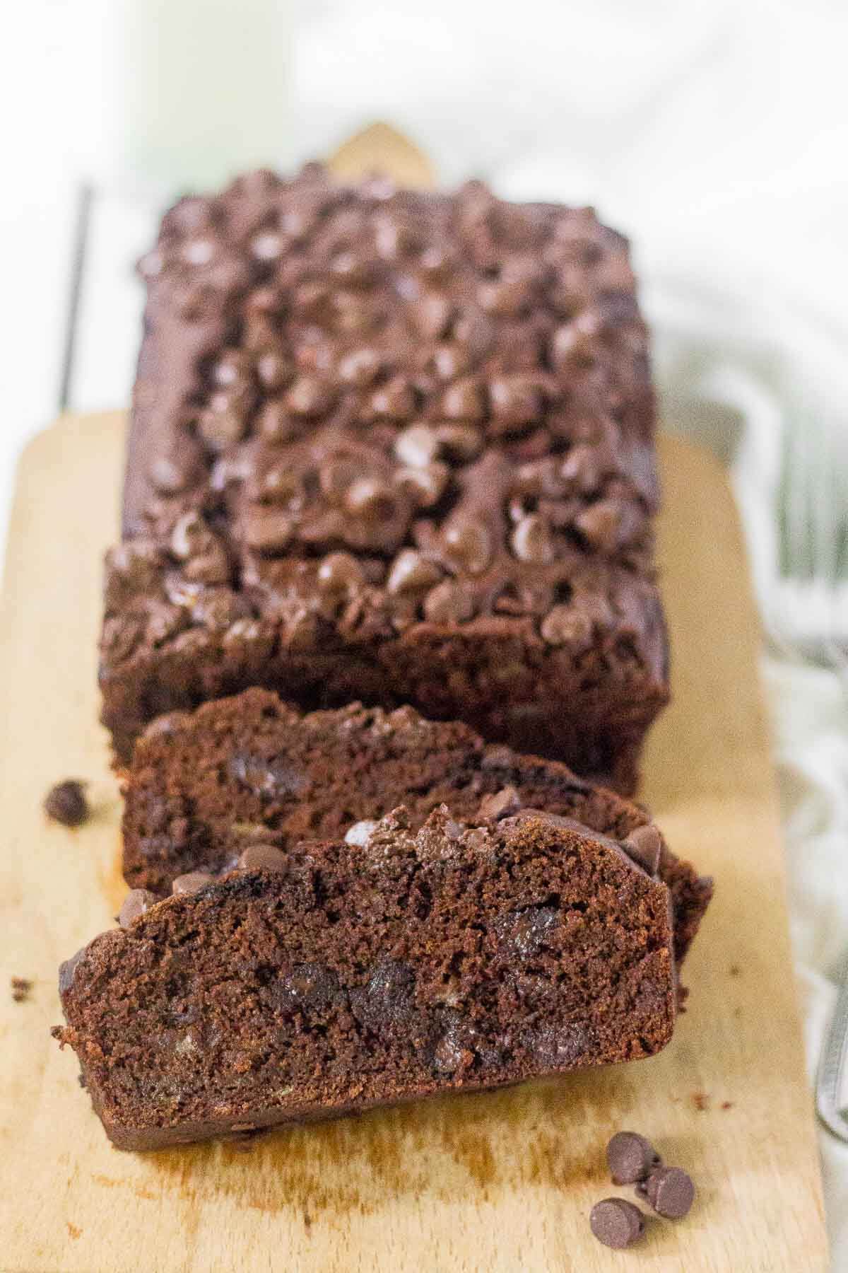 loaf of healthy chocolate chip banana bread with first couple of pieces sliced