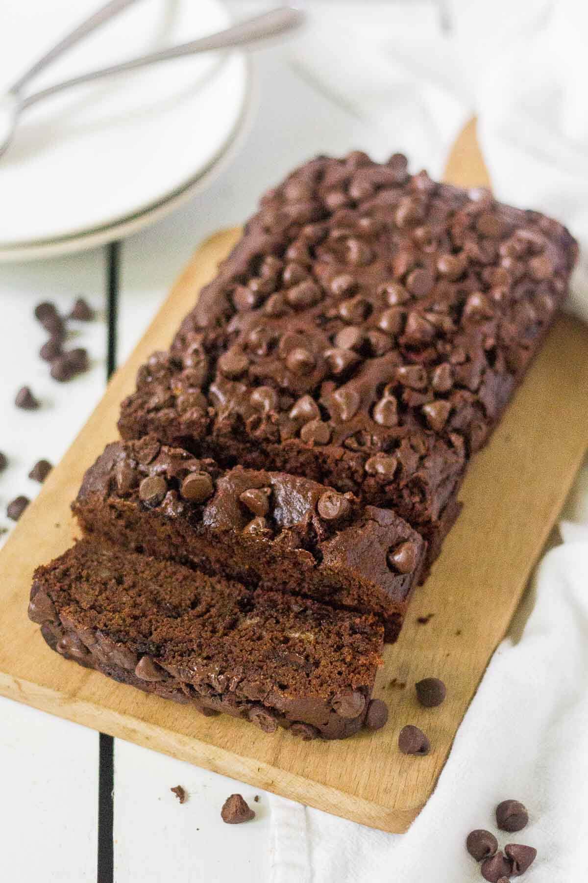 loaf of healthy chocolate chip banana bread with first two pieces cut