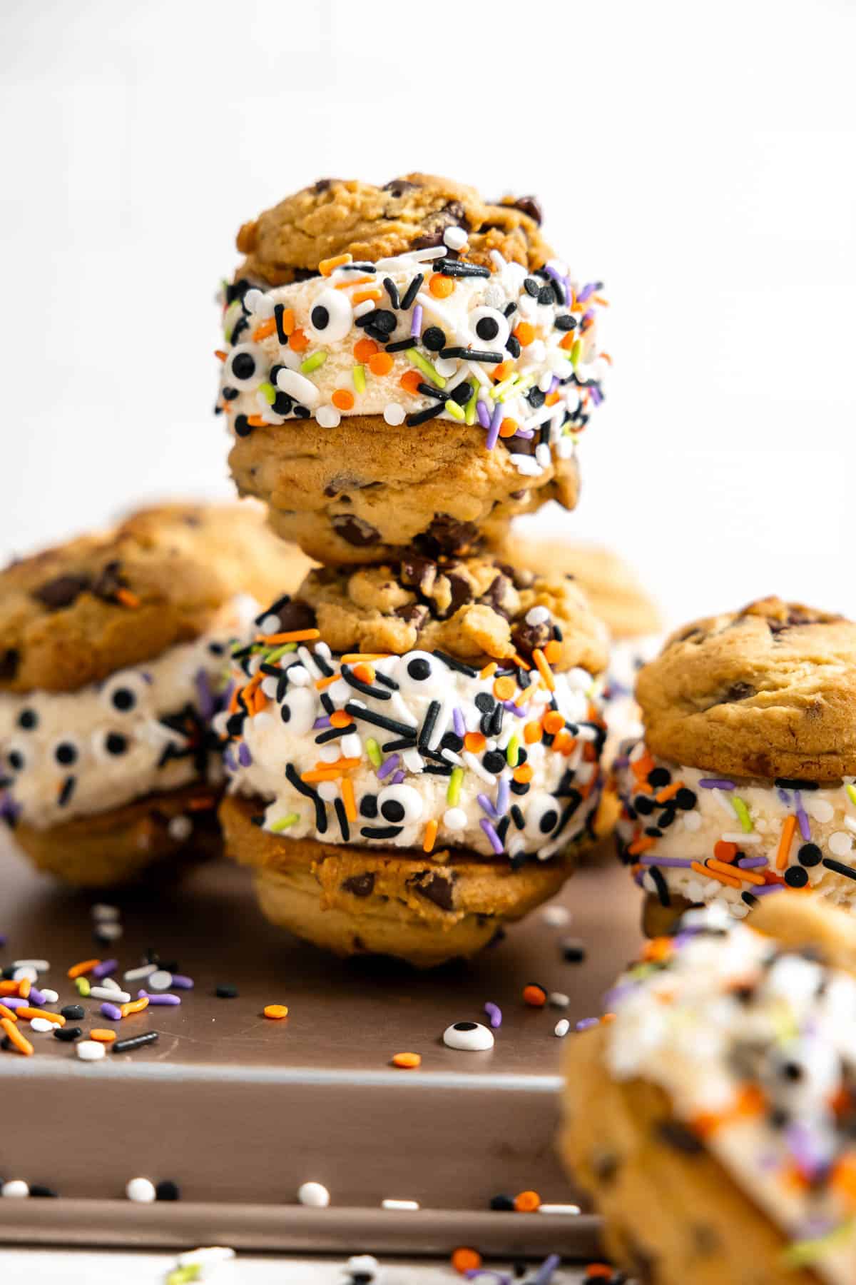 two halloween ice cream sandwiches stacked on a platter.