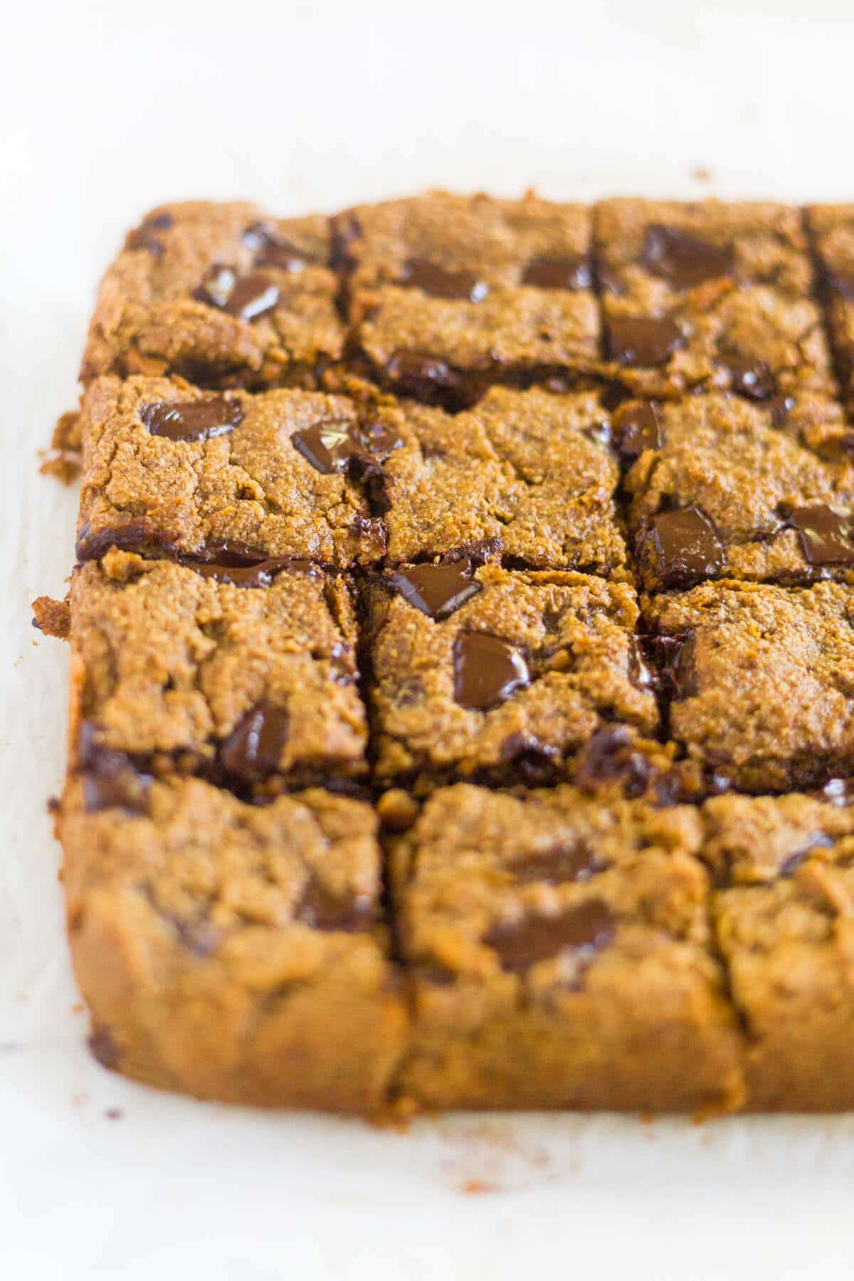 Paleo Pumpkin Chocolate Chunk Blondies are a healthier alternative to all your pumpkin desserts! These paleo blondies are thick and chewy and filled with pumpkin and extra large chocolate chunks.