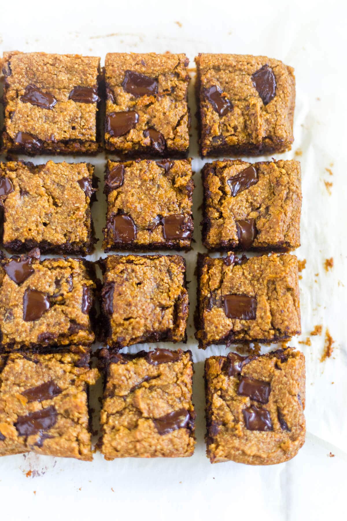 Paleo Pumpkin Chocolate Chunk Blondies are a healthier alternative to all your pumpkin desserts! These paleo blondies are thick and chewy and filled with pumpkin and extra large chocolate chunks.