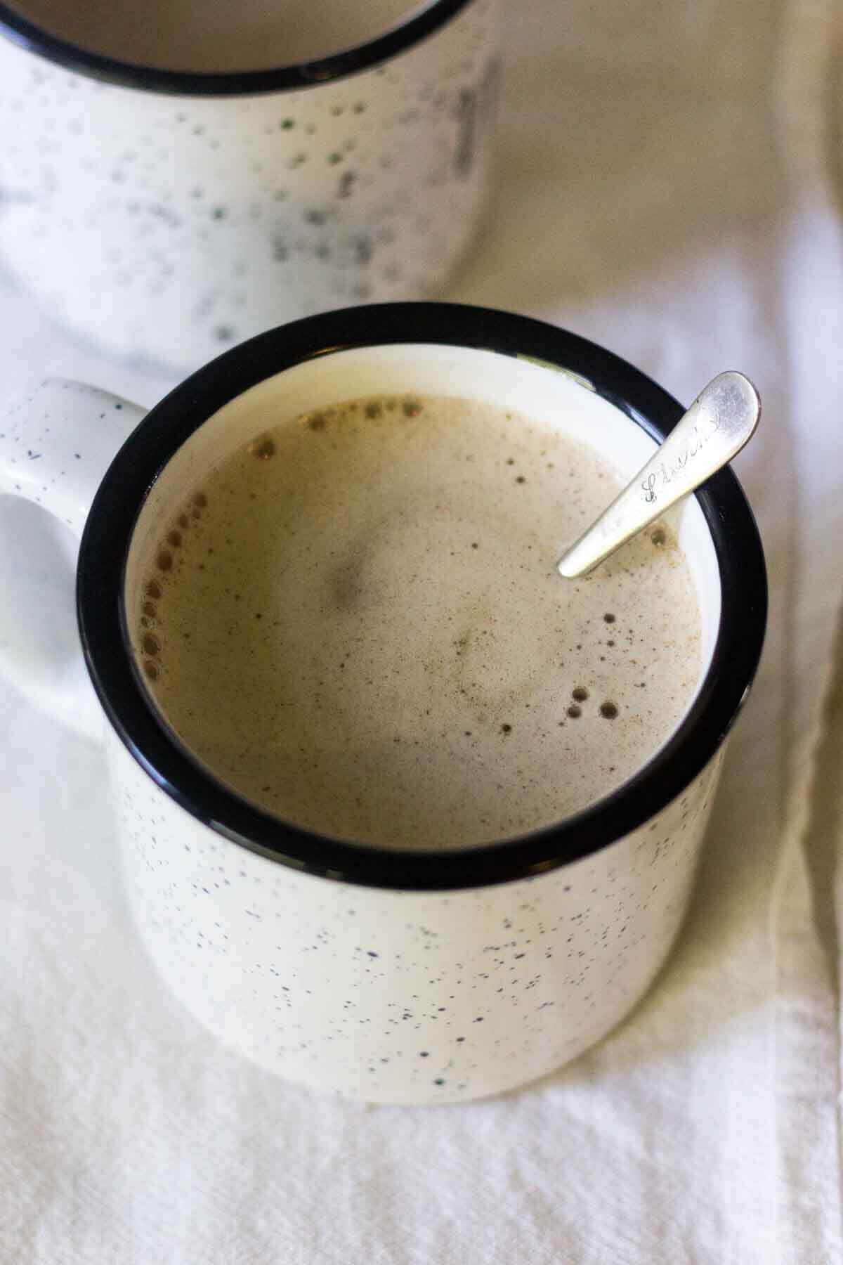 A tiny silver spoon in a mug of Bulletproof coffee