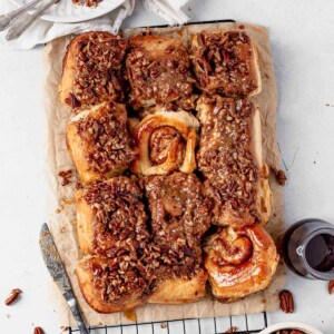 sticky buns on a wire rack with a few flipped over to see the swirl