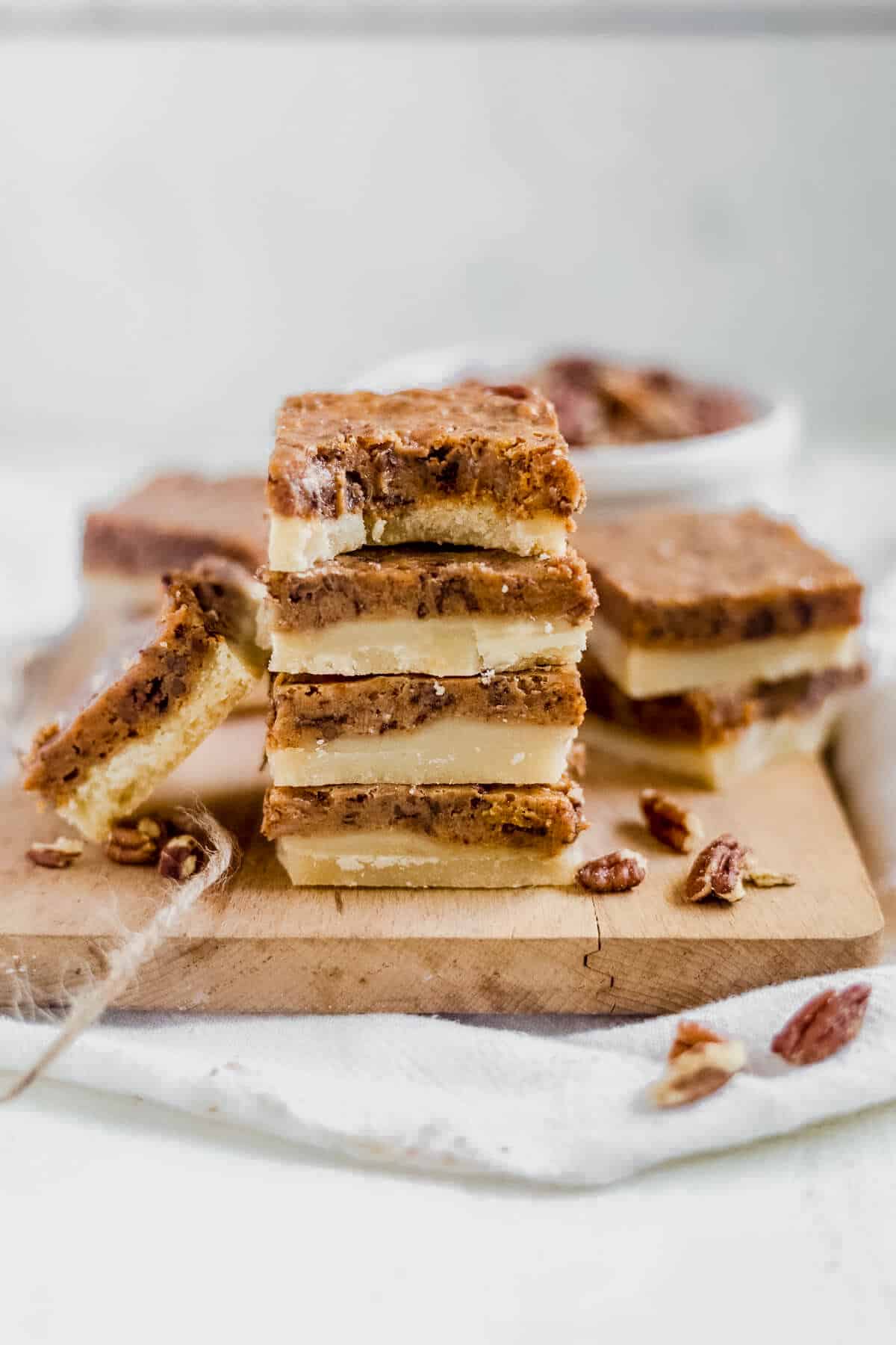 a stack of pumpkin pecan bars on a cutting board