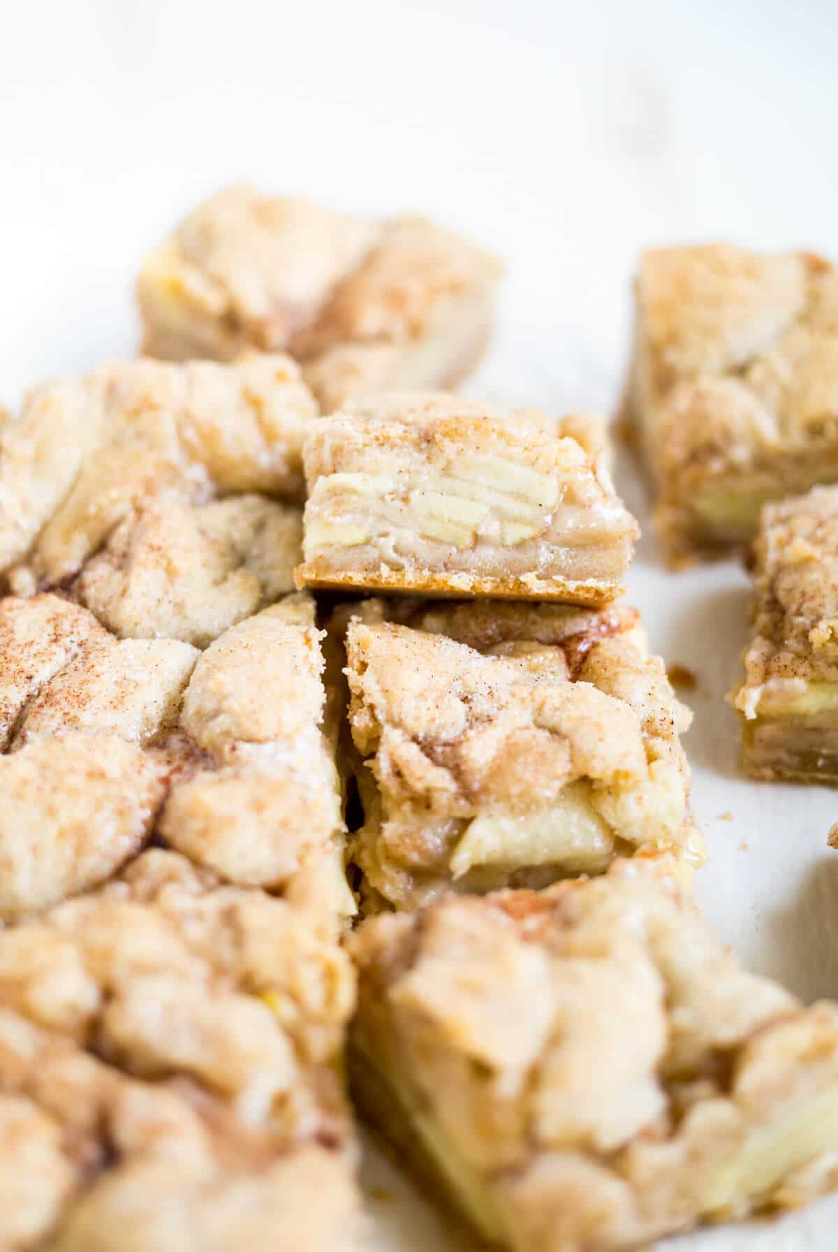 Sweet and gooey snickerdoodle apple pie bars cut up into squares