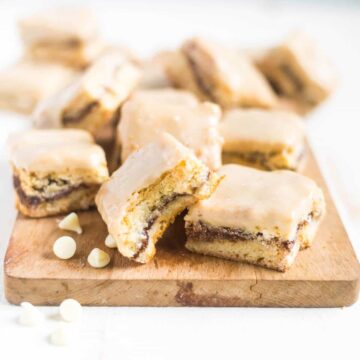 White chocolate chai spiced blondies are a mix between a cake like bar and a thick and chewy blondie. They're dense and filled with white chocolate chips, melted white chocolate and inside is a cinnamon swirl filled with chai spices!