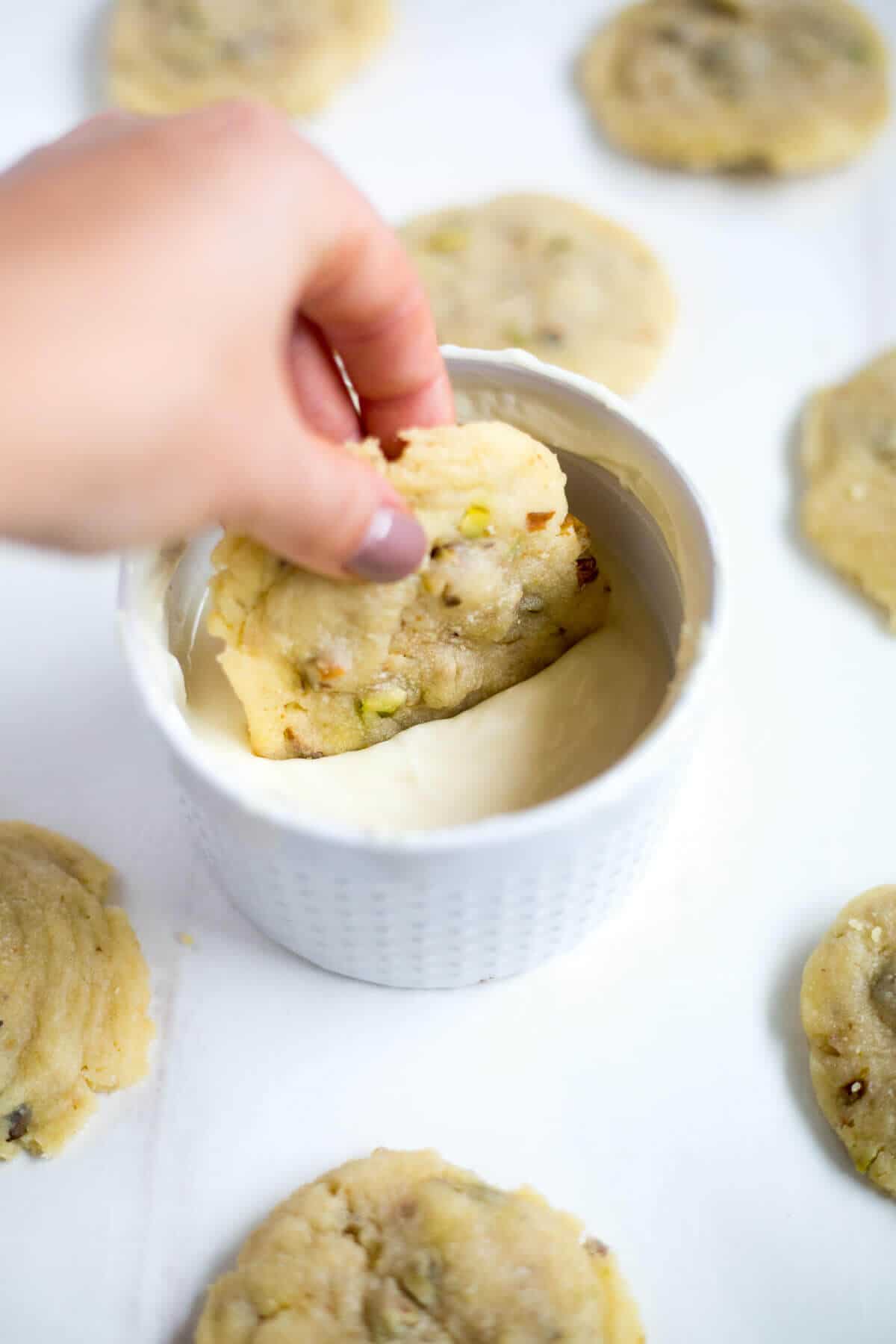 These white chocolate pistachio cookies are such a festive Christmas cookie recipe. They're studded with chopped green pistachios and white chocolate chips then dipped in white chocolate to make them look just as good as they taste.