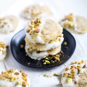 These white chocolate pistachio cookies are such a festive Christmas cookie recipe. They're studded with chopped green pistachios and white chocolate chips then dipped in white chocolate to make them look just as good as they taste.