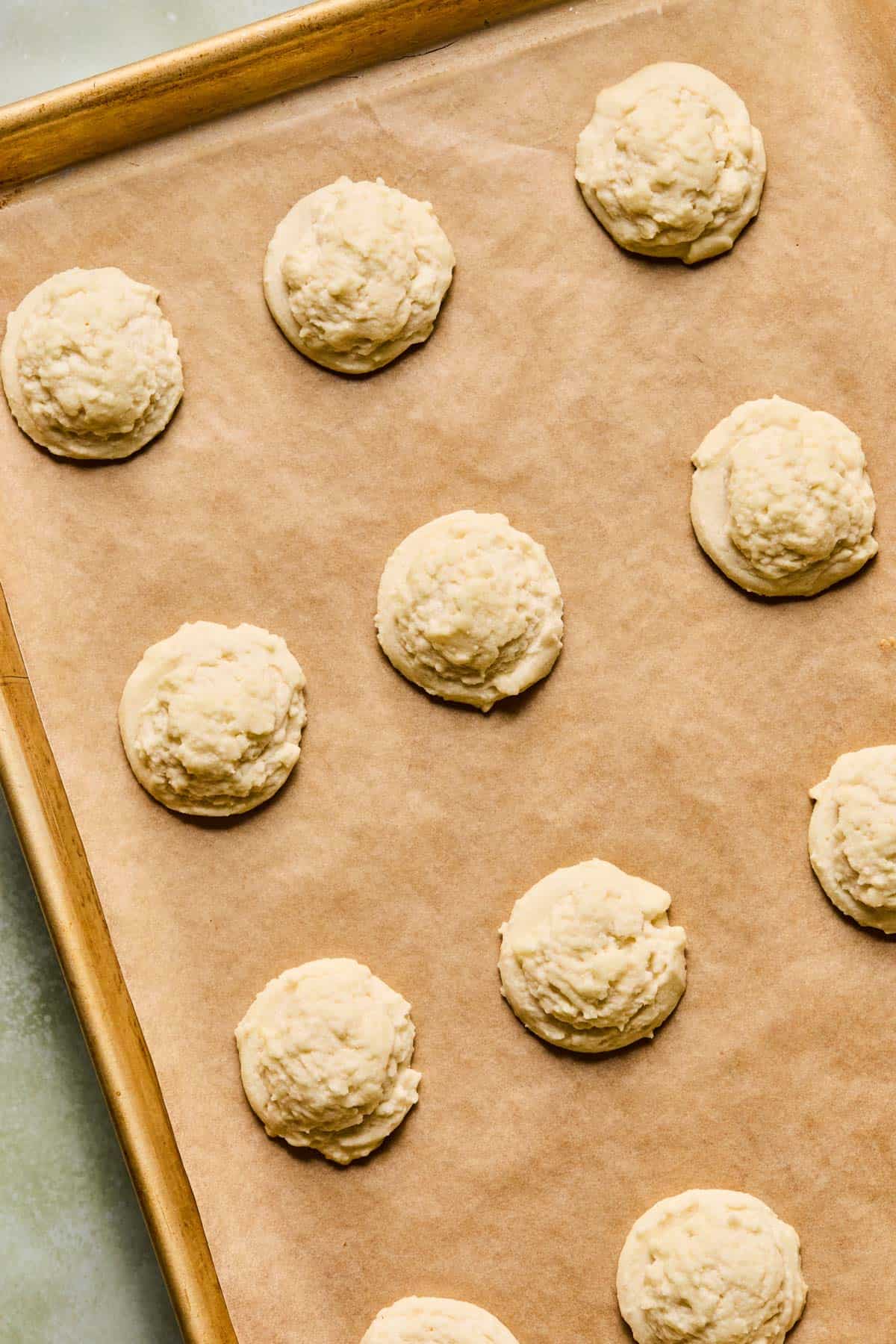 baked melting moments cookies cooling on a sheet pan.
