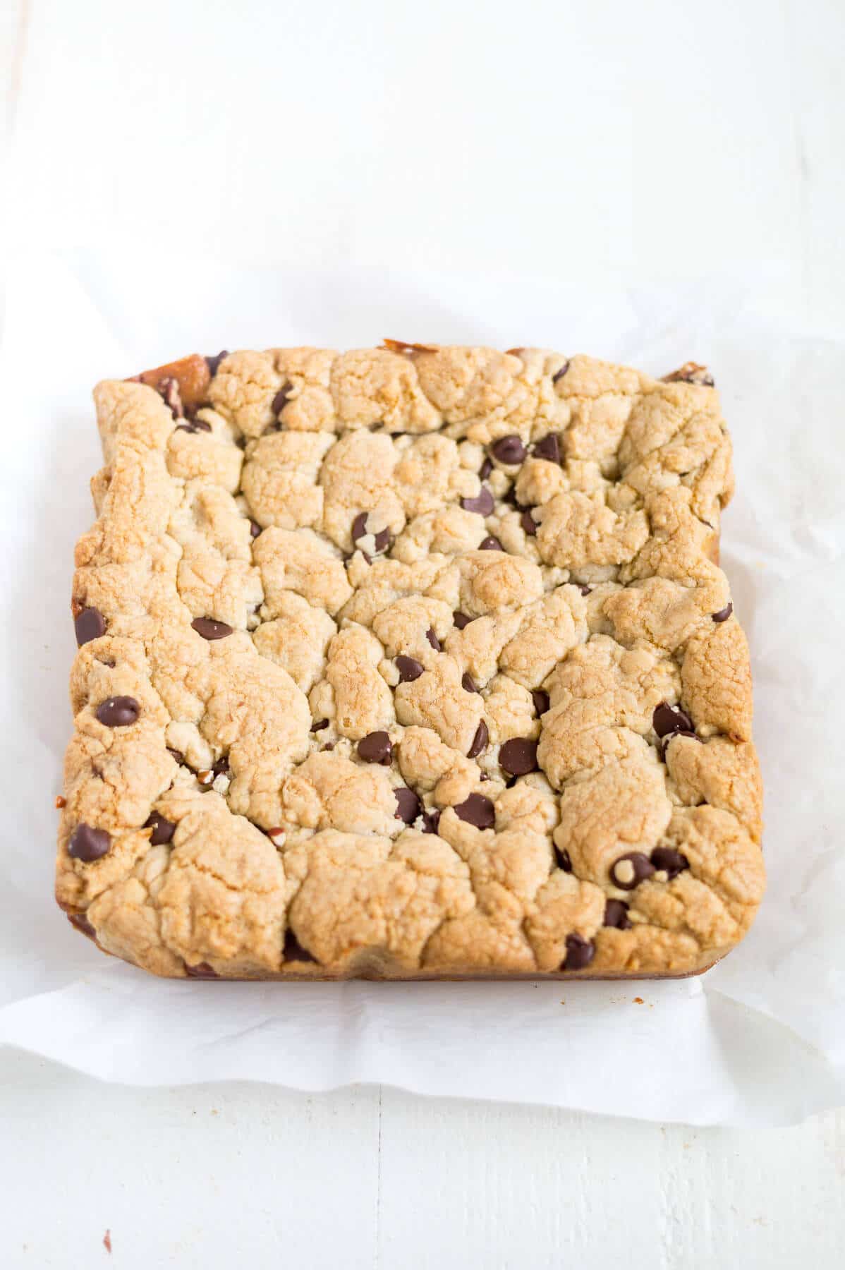 Thick and chewy turtle cookie bars! The base of this recipe is a chocolate chip cookie. You'll split the dough in half and add some caramel and pecans to the middle for an easy, chewy dessert!