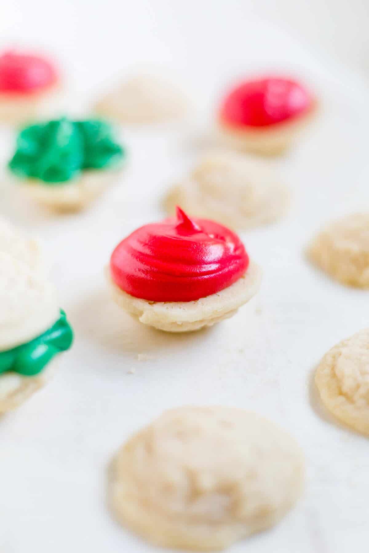 a Melting moments sandwich cookies with red icing lying face up