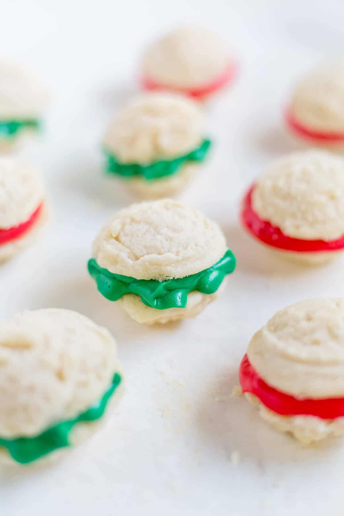 Melting moments sandwich cookies are a must-make Christmas cookie! They're tiny cookies sandwiched with a thick and creamy frosting dyed red and green. This festive cookie recipe will be a new family favorite.