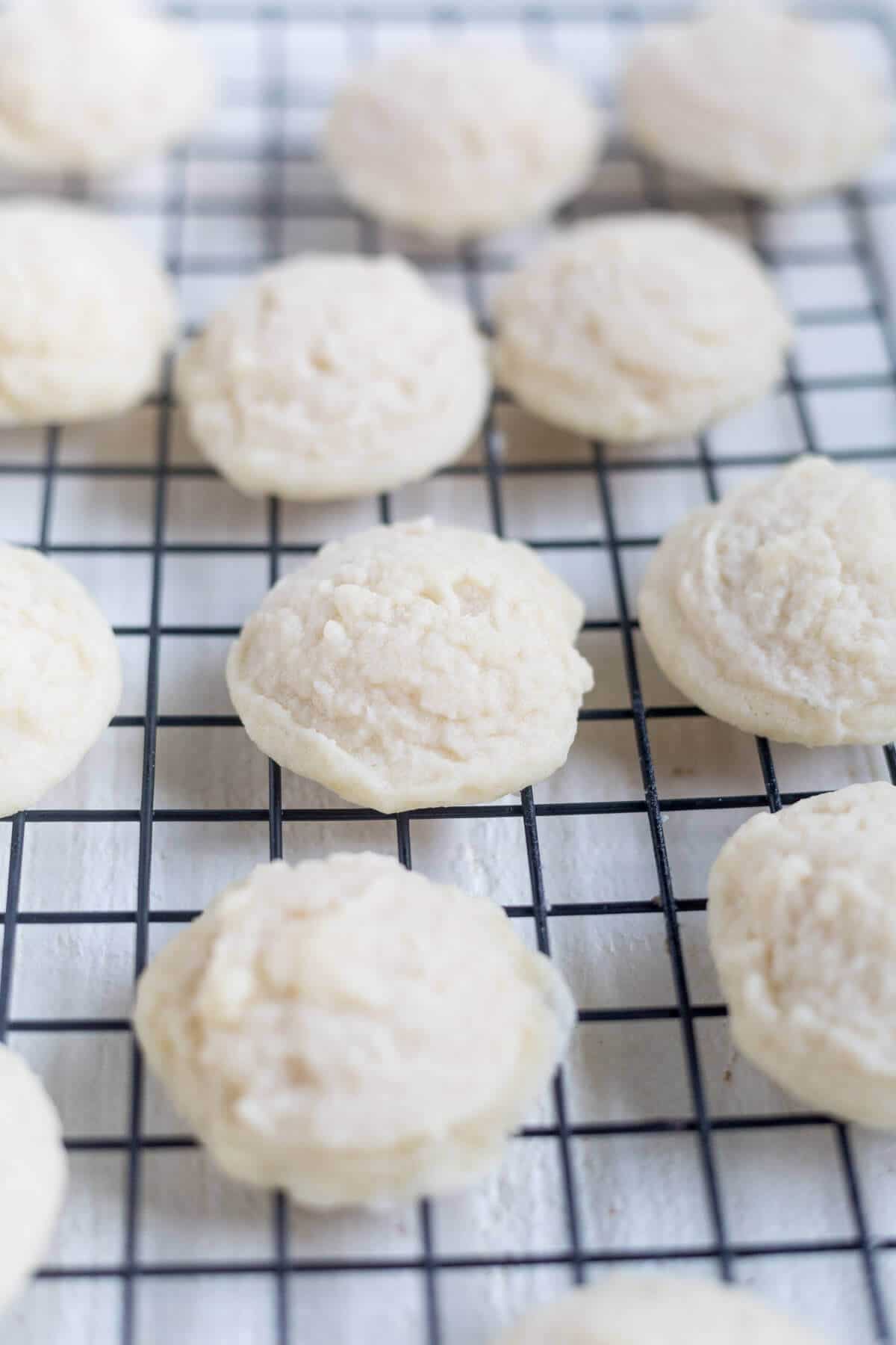 Melting moments sandwich cookies cooling on a cooling rack with no icing