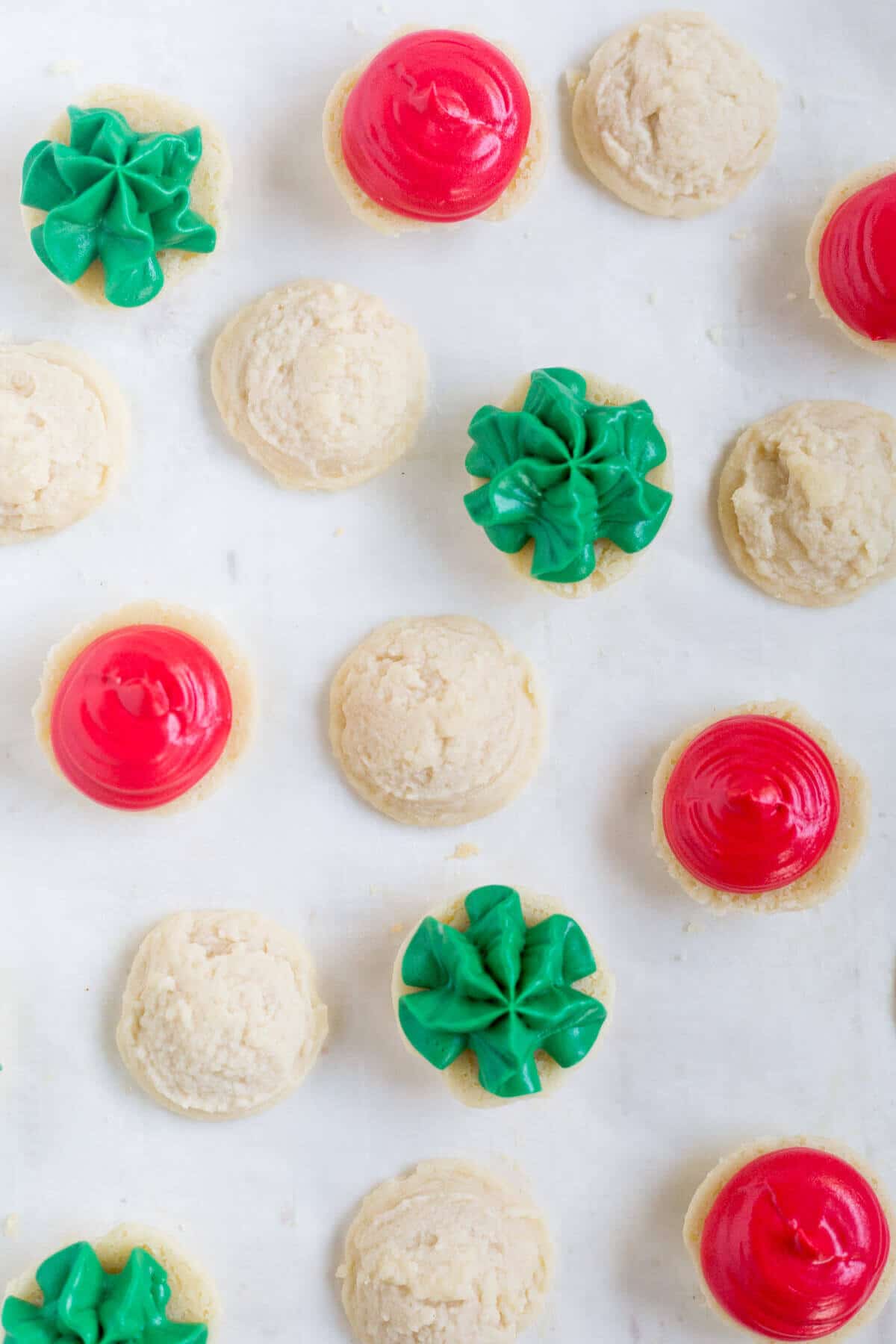 Melting moments sandwich cookies are a must-make Christmas cookie! They're tiny cookies sandwiched with a thick and creamy frosting dyed red and green. This festive cookie recipe will be a new family favorite.