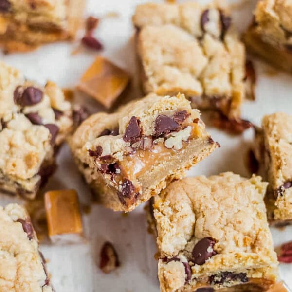 turtle cookie bars cut into squares and stacked