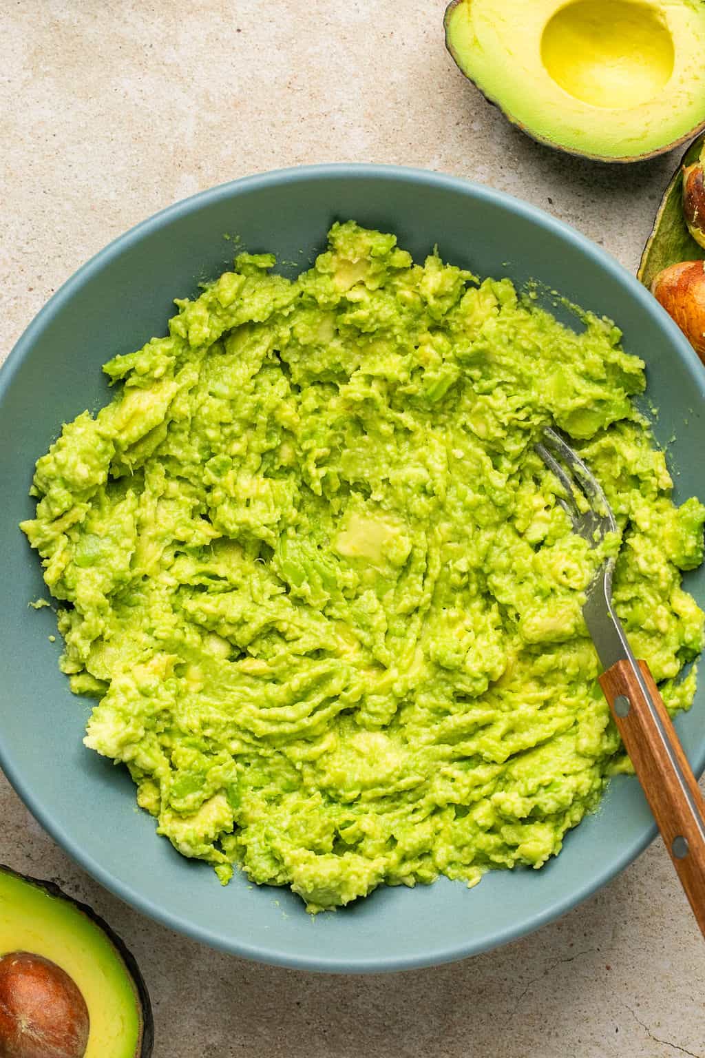 avocado mashed in a bowl with a fork