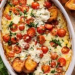 crusty bread dipped into caprese dip