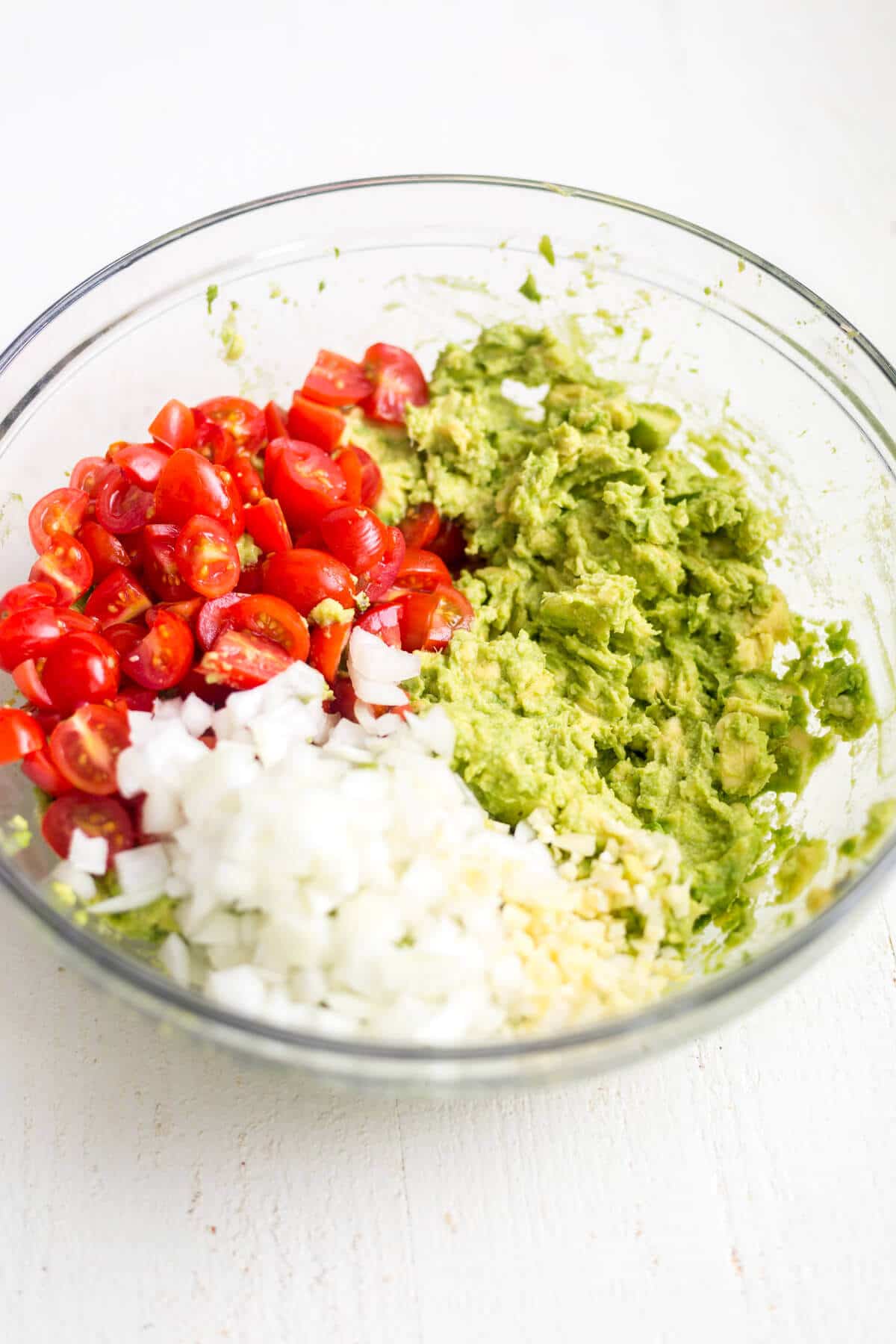 healthy guacamole ingredients in a glass bowl