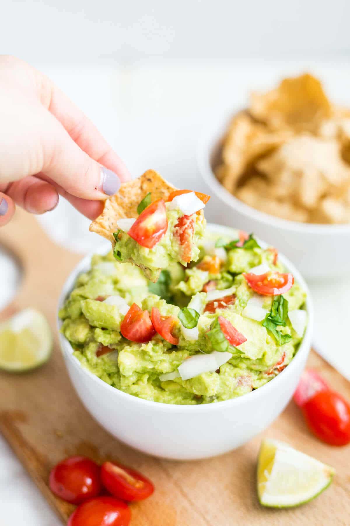 chip dipping into healthy guacamole 