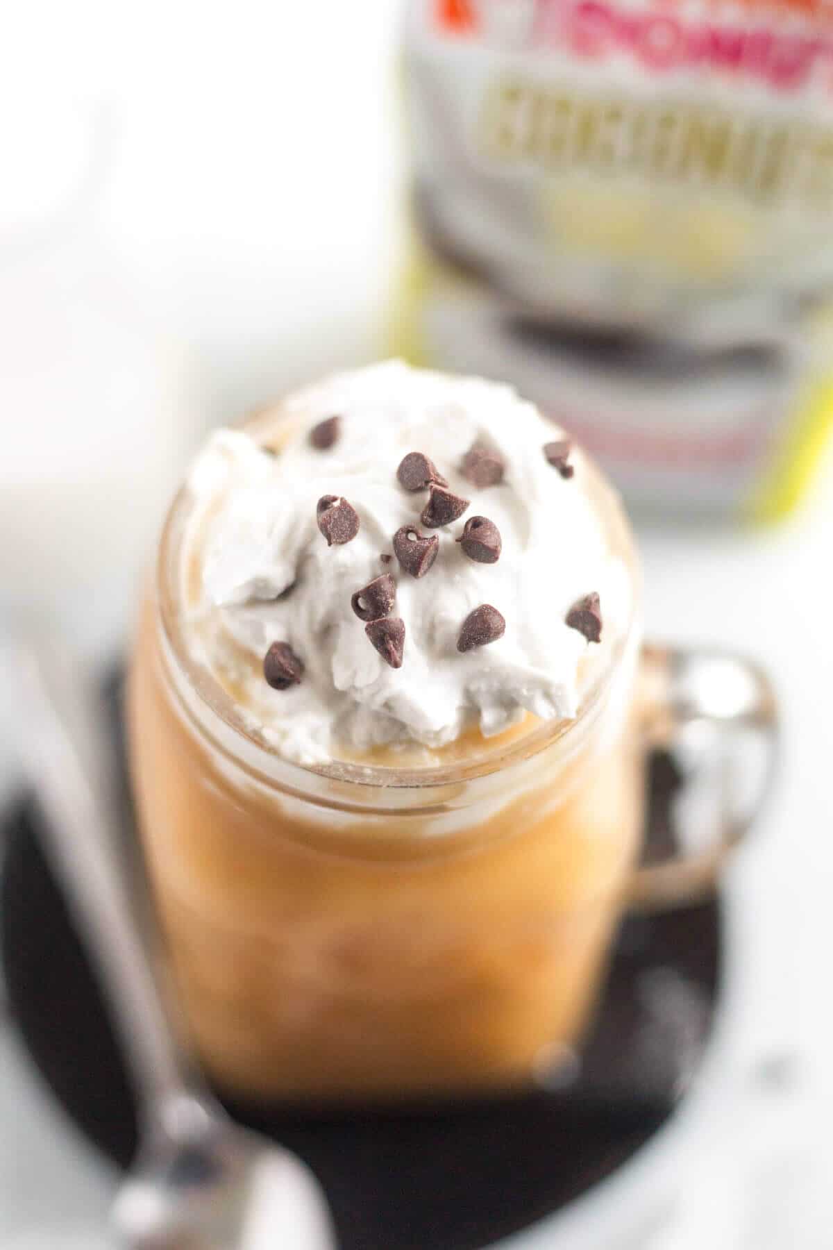 aerial view of mocha coconut iced coffee topped with whipped cream and mini chocolate chips