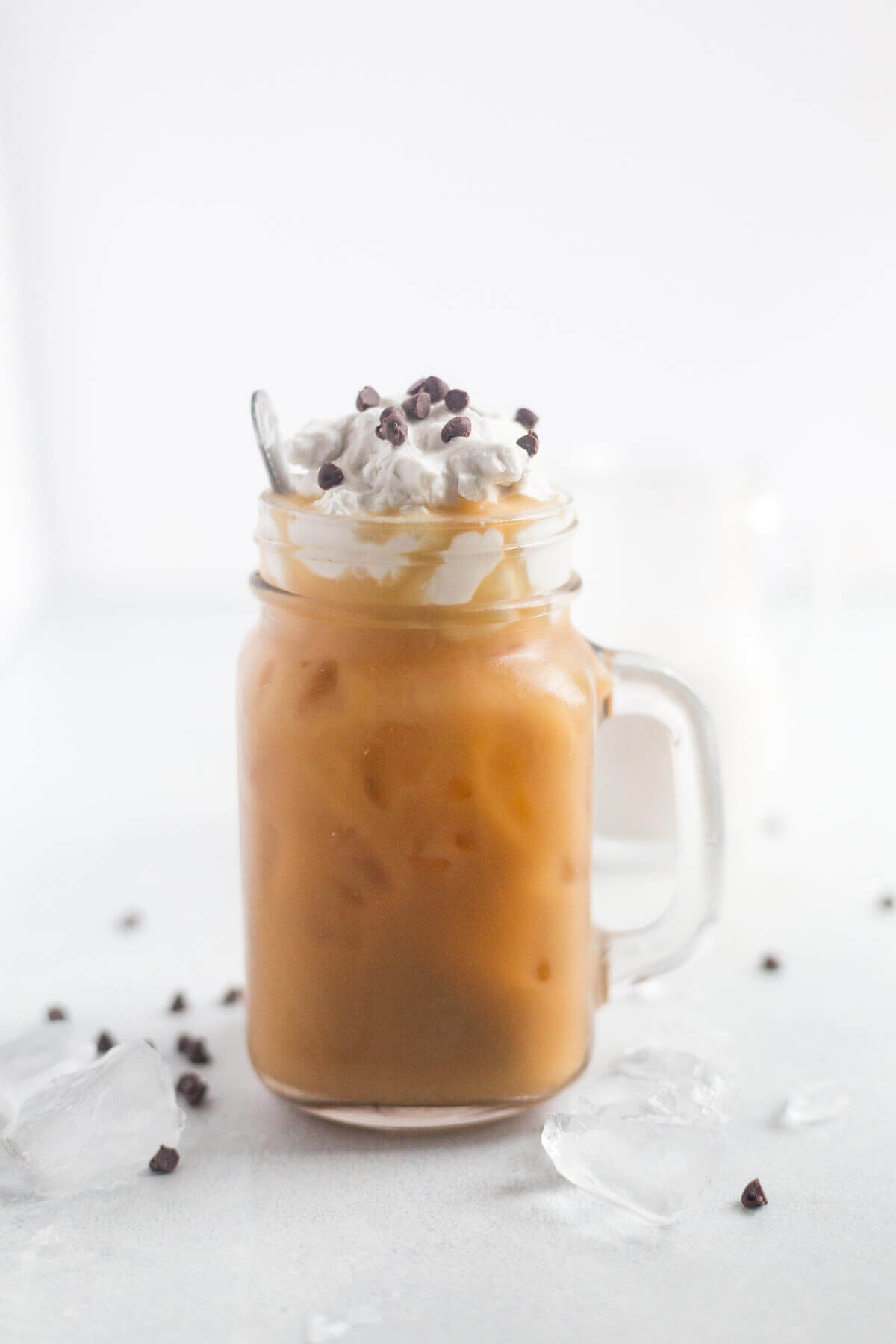 coconut iced coffee in a glass mug on a counter