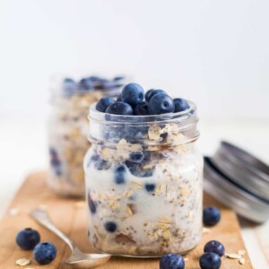 blueberry overnight oats in a mason jar topped with fresh blueberries