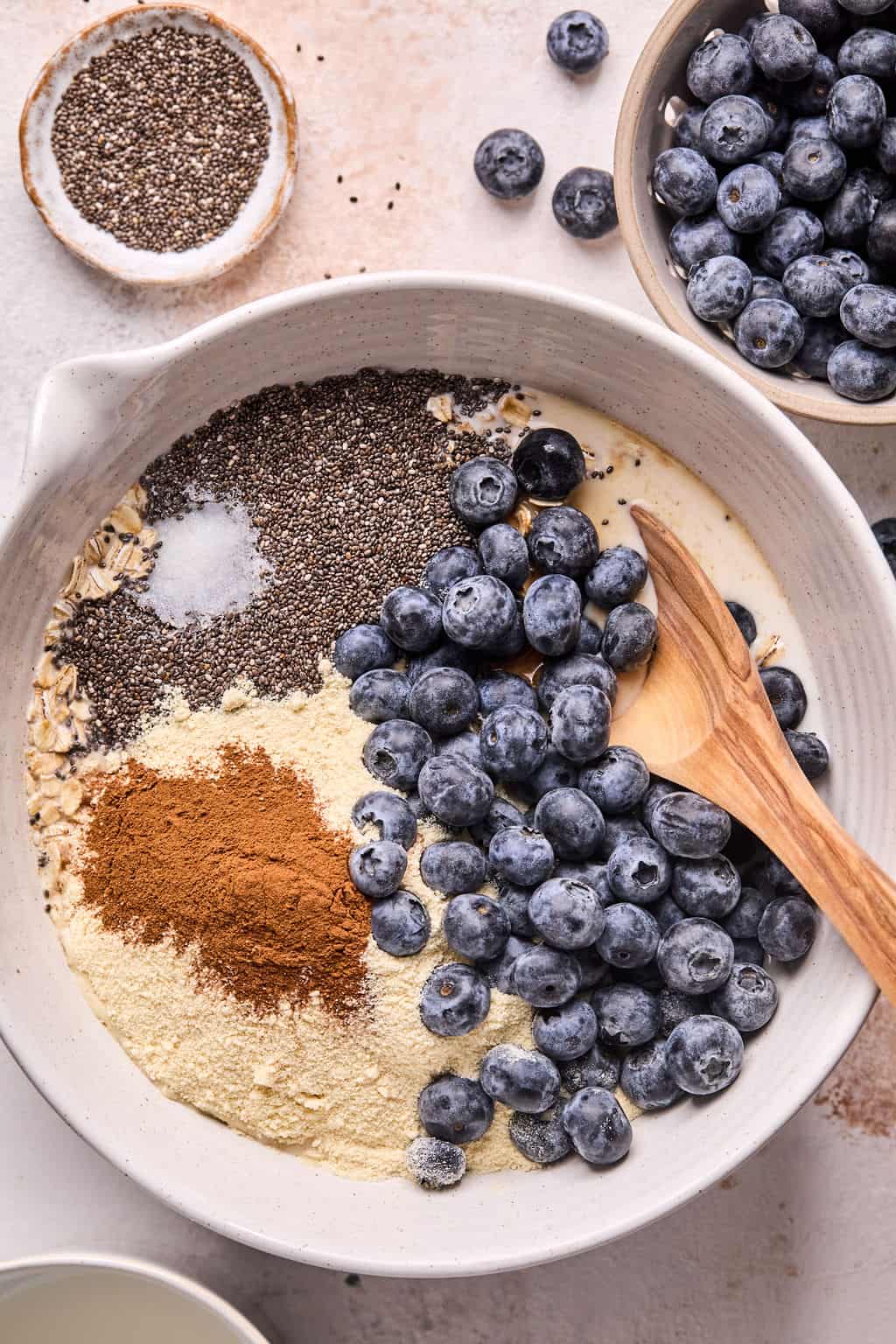 ingredientes for blueberry overnight oats in a mixing bowl.