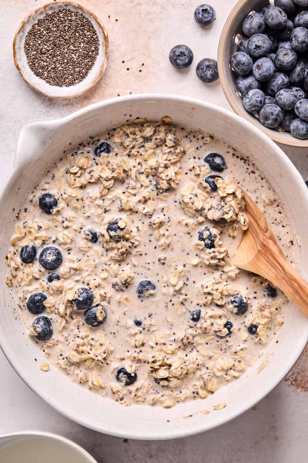 blueberry overnight oats in a mixing bowl before refrigerating.